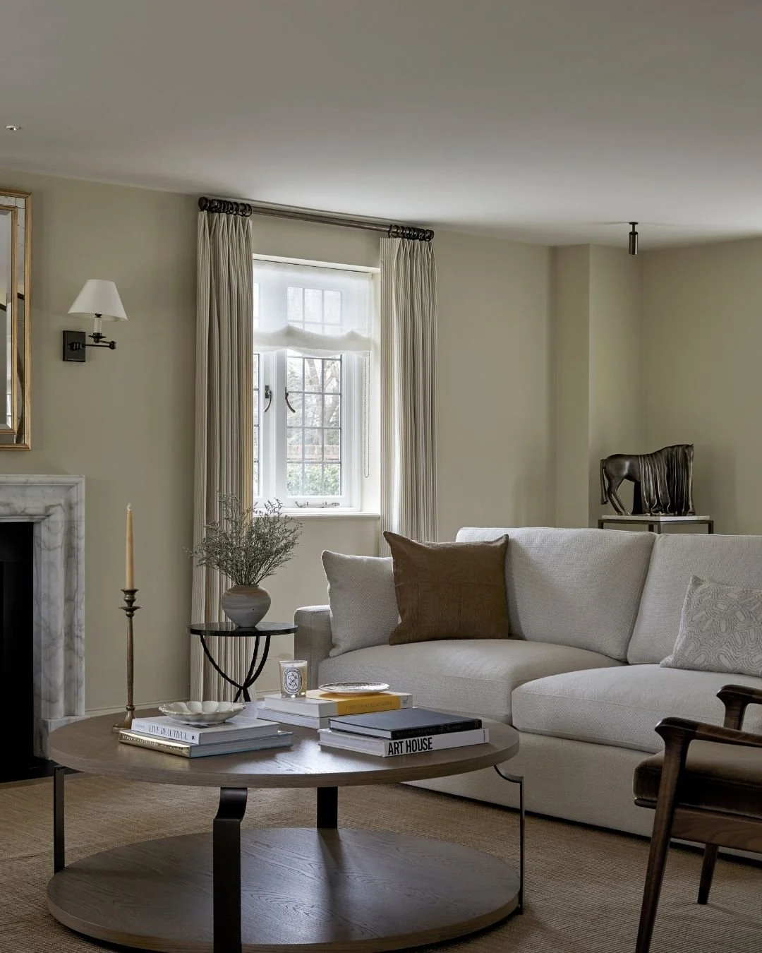 1. Calm neutral living room at Cottage House by Margot Tsim Interiors, with bespoke window treatments, layered natural textures and dark timber furniture.
