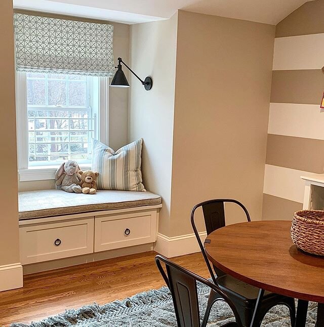 This playroom is complete with a fun print roman shade and a bench cushion! 
#readingspot #playroomdesign #stripewall #visualcomfort #playroom #customwindowtreatments #customshades #stouttextiles