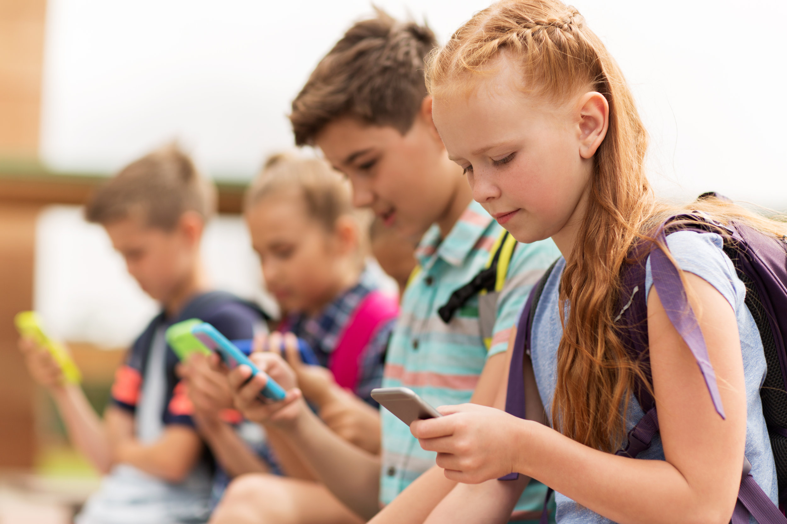 Kids looking at phones.jpg
