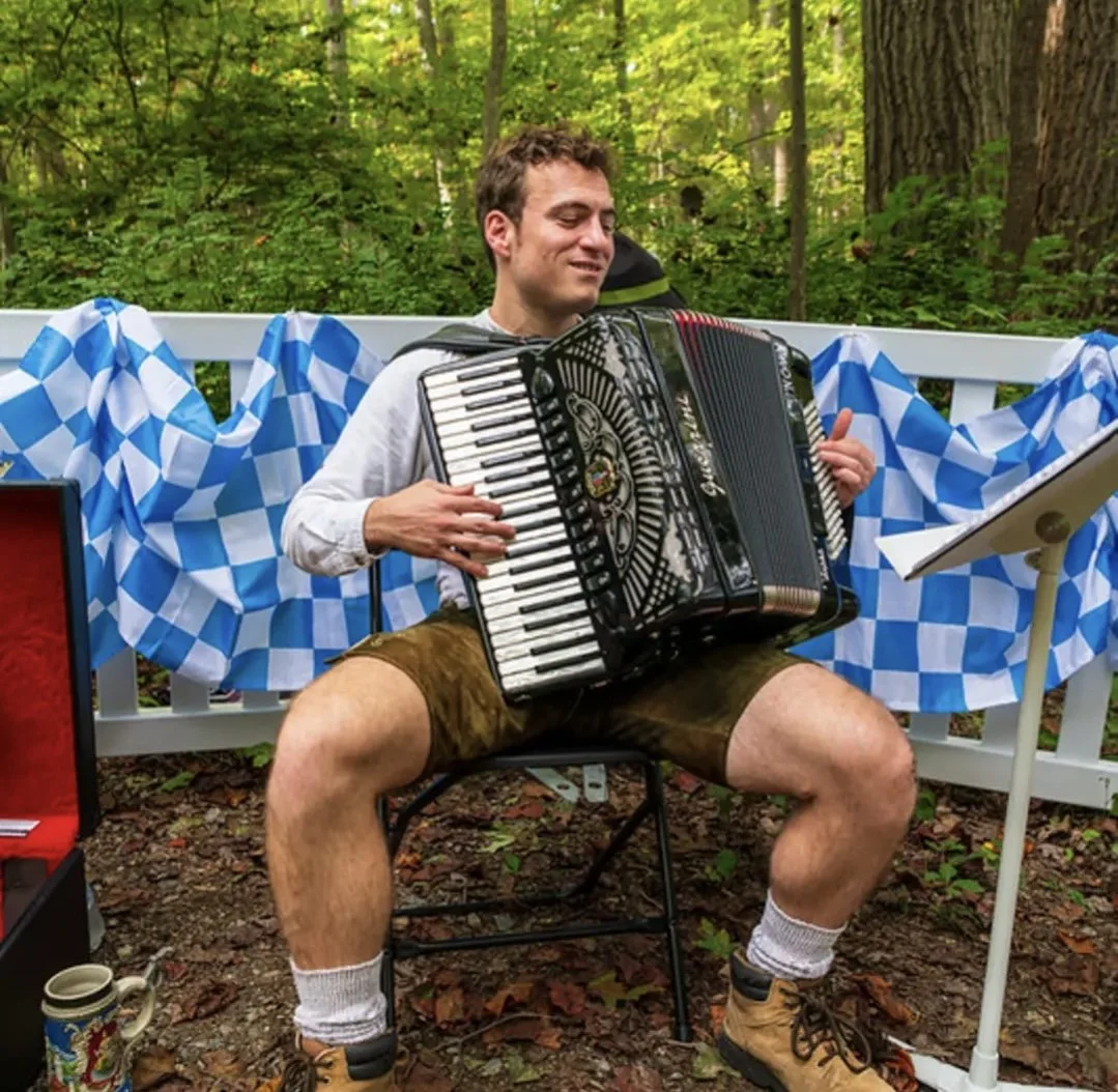 Justin Paschalides performing accordion outdoors