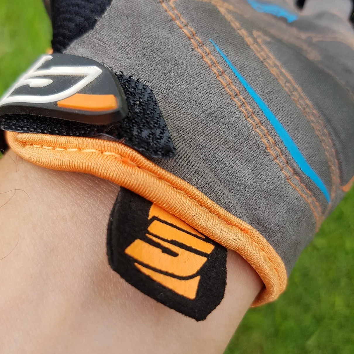 Tab to help pull the glove on easier