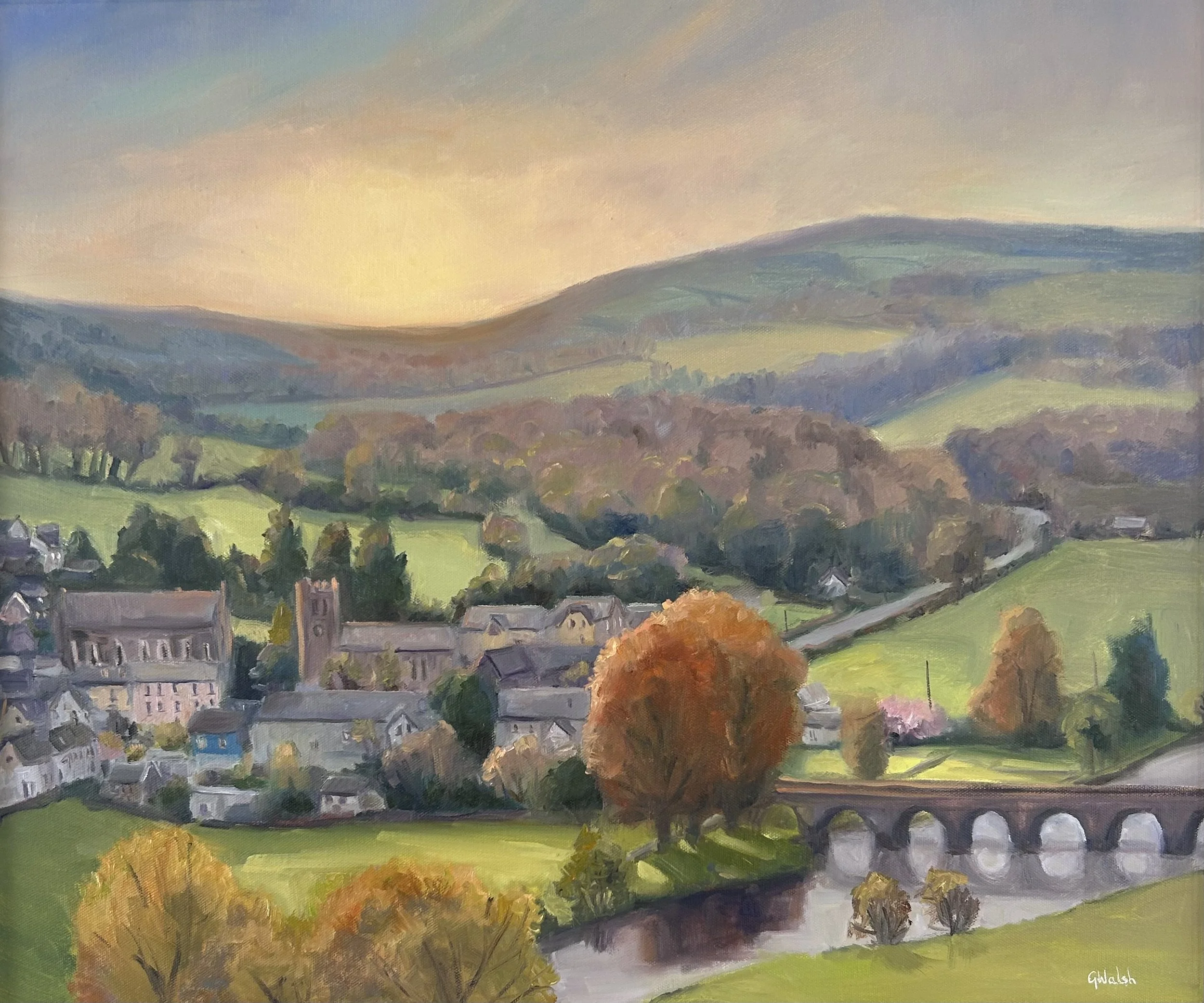 Oil painting of the historic village of Inistioge, Kilkenny, showing traditional stone buildings and lush greenery.