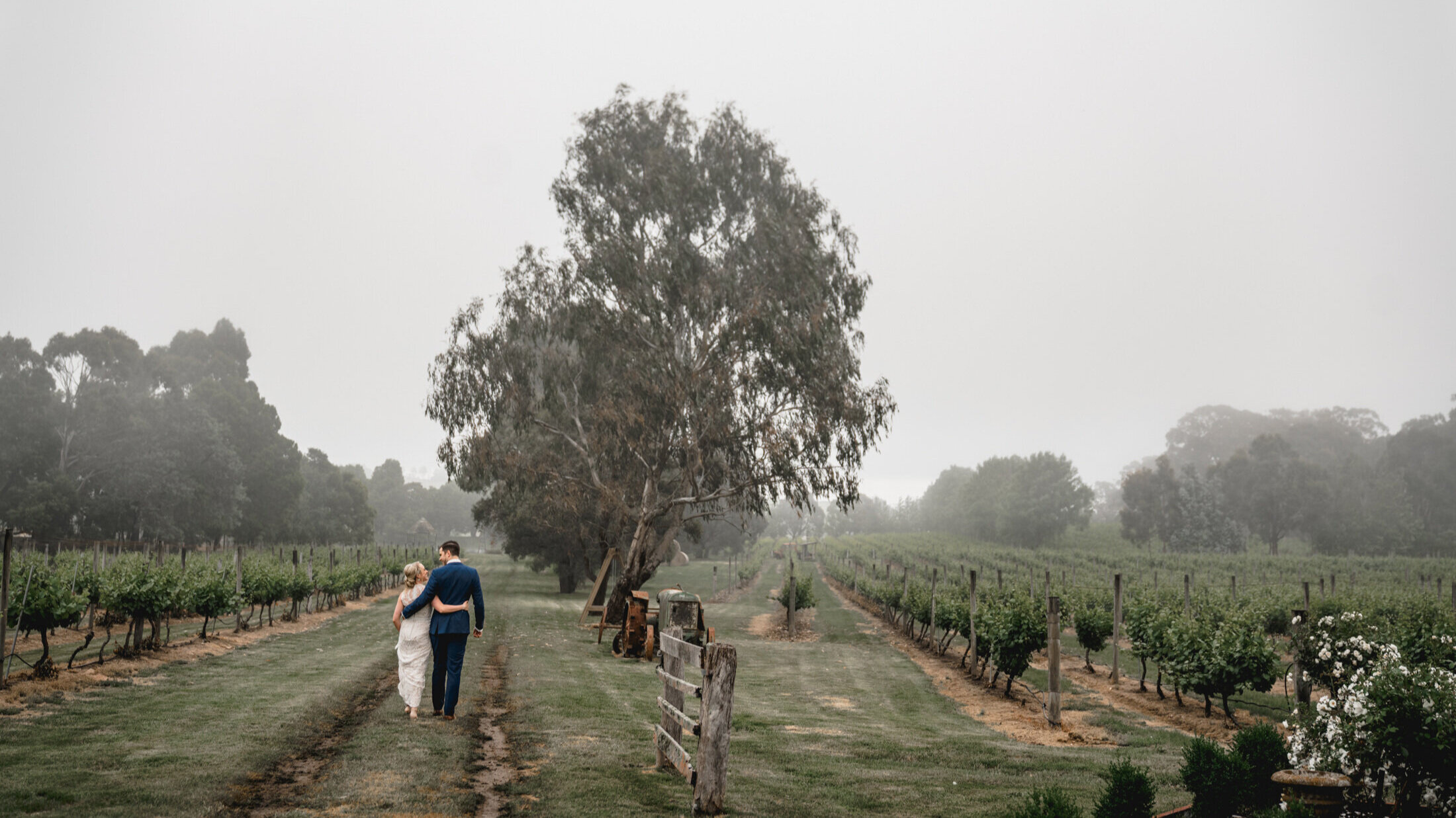 Wedding-Bride+and+Groom+walking-winery-fineartweddings-wheretheheartis-weddingvideomelbourne-weddingfilmsmelbourne.jpg