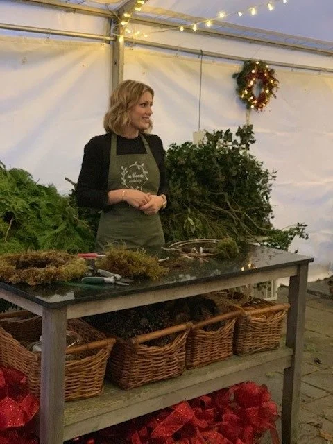 Alex teaching wreath making to a marquee of 60 people