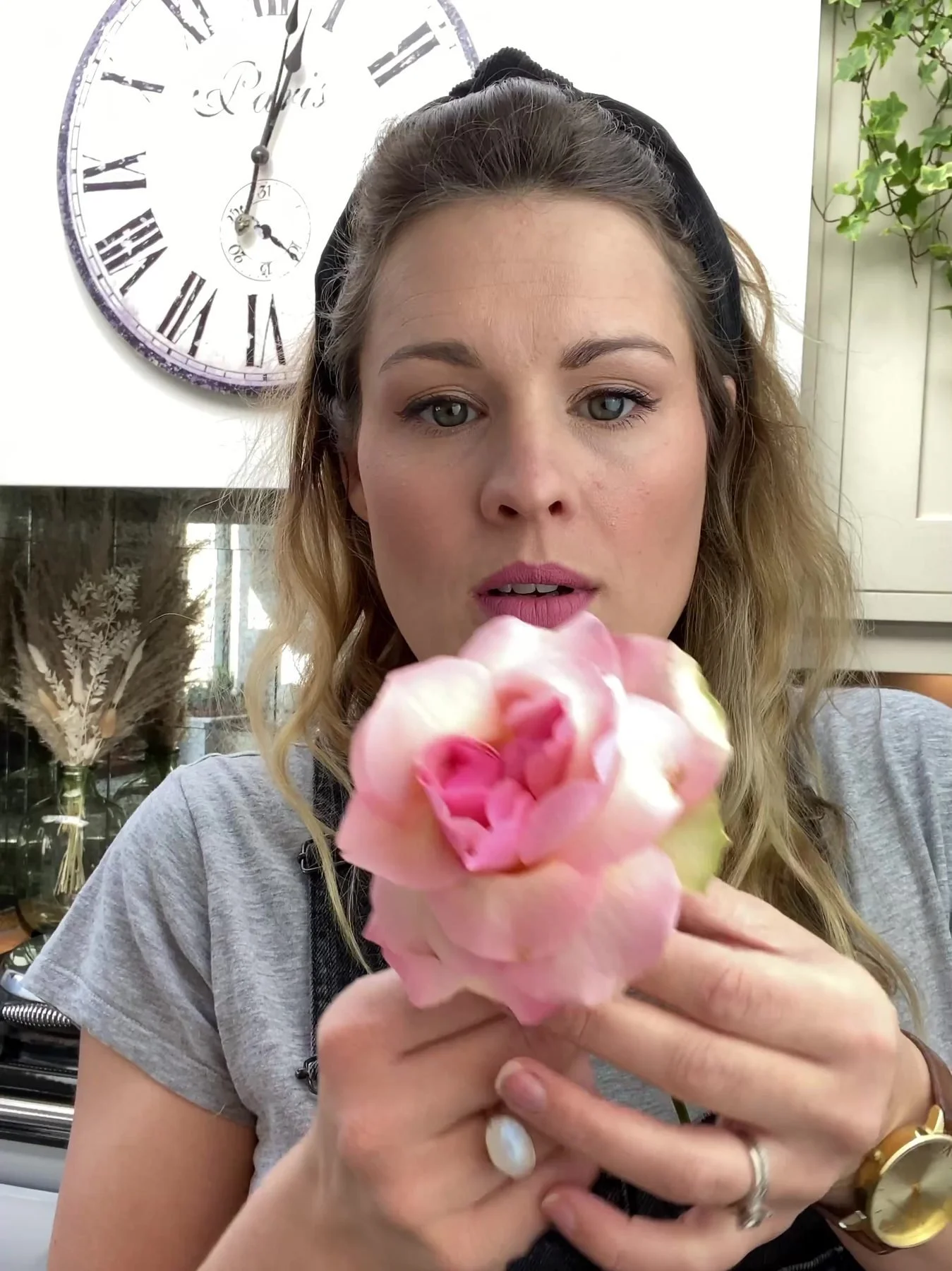 Alex showing how to open a rose, petal by petal