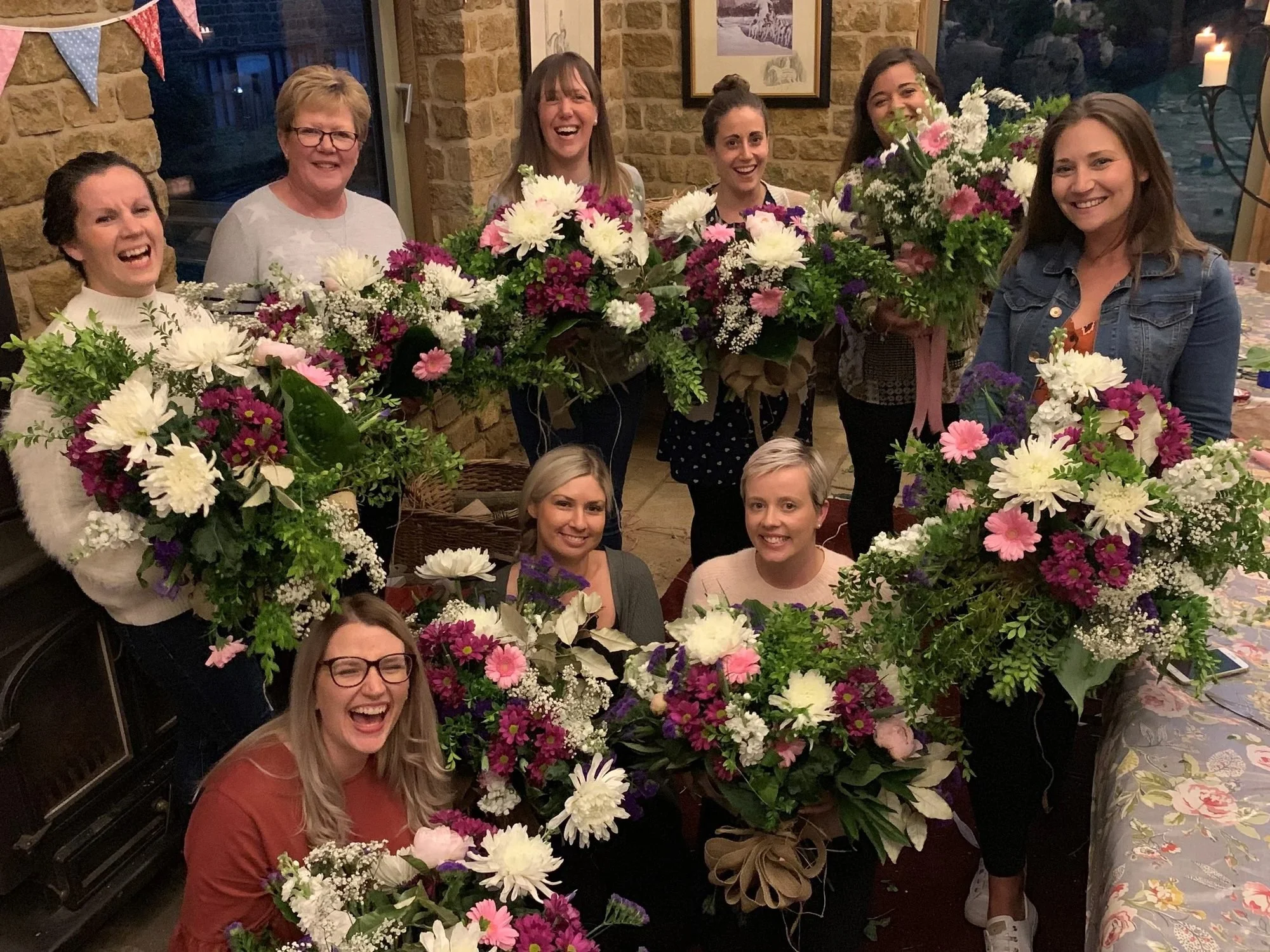 Friends holding bouquets at a private workshop