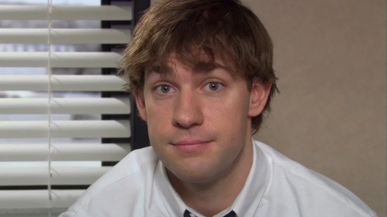 A photo of Jim Halpert from The Office in front of the interview wall.