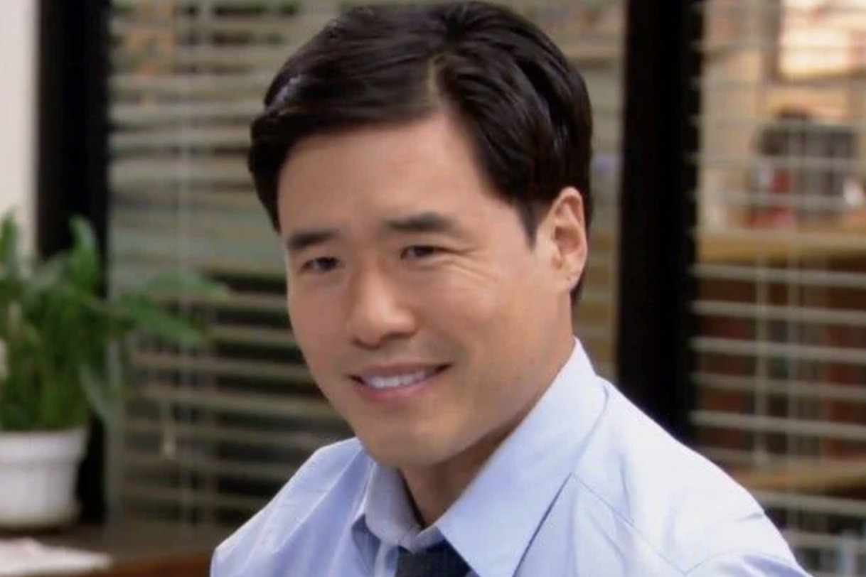 A photo of "Asian Jim" or actor Randall Park, from The Office episode where he is featured in the cold open.