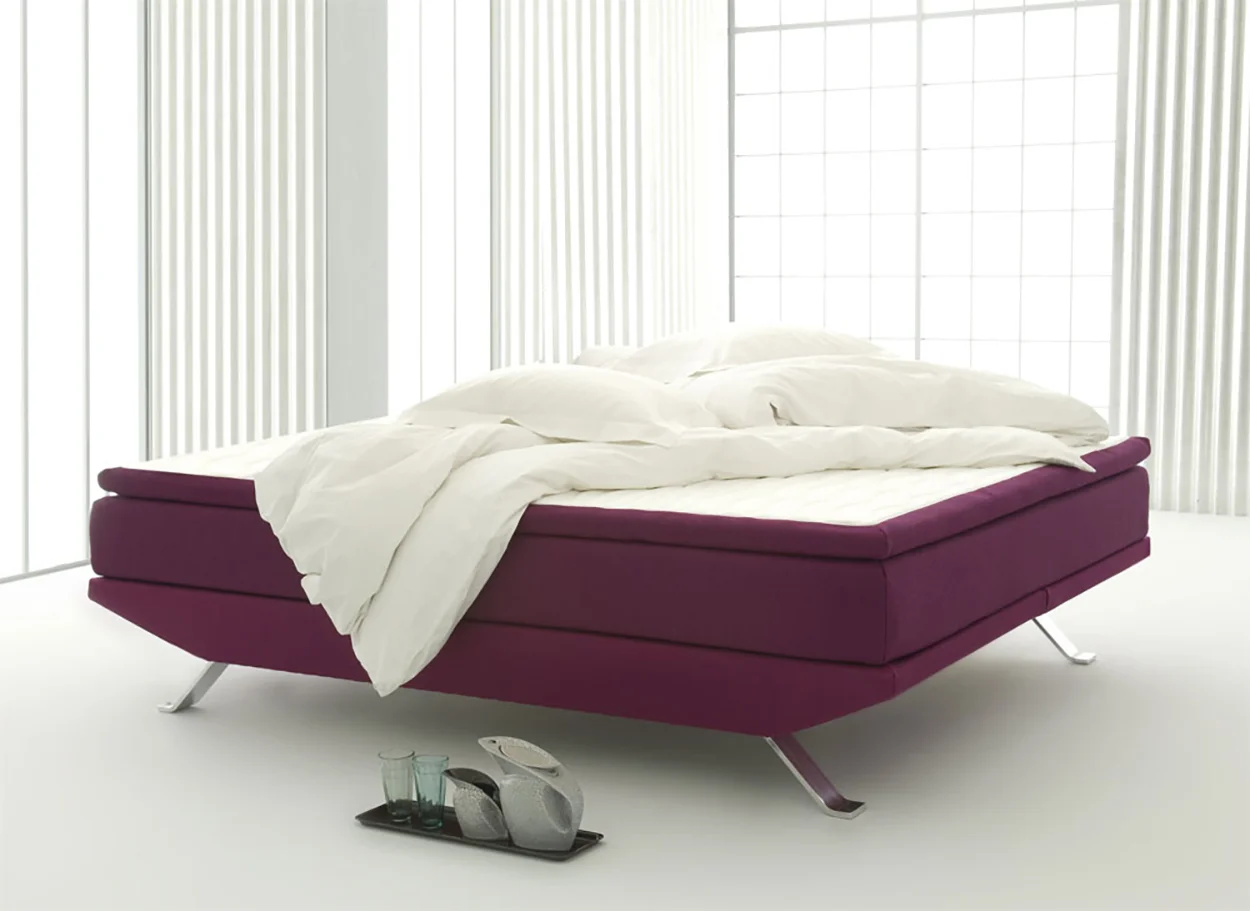  The metal legs and a tapered frame provide a sense that the bed is floating.    