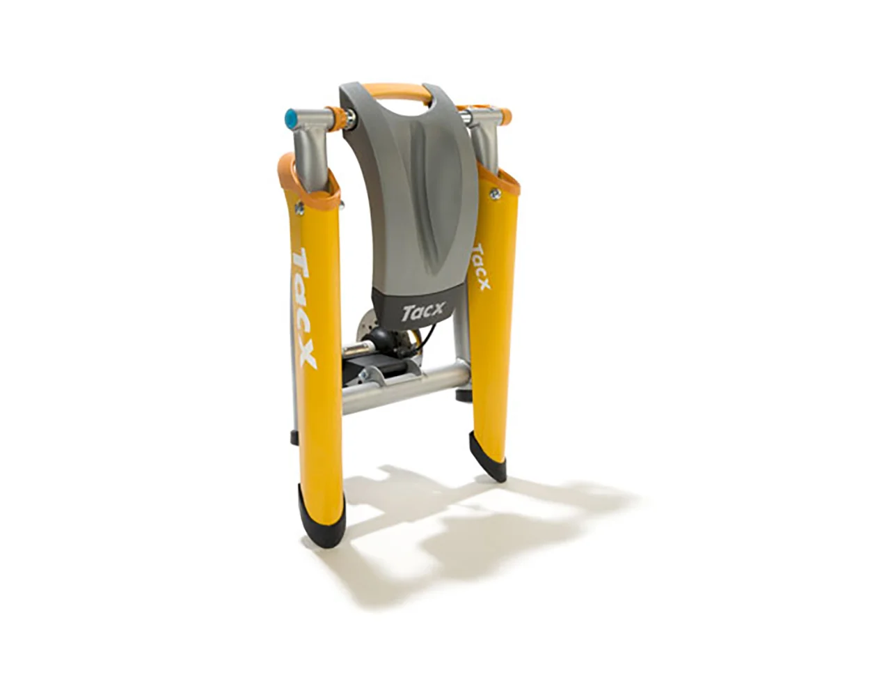  The trainer in the folded up state. The front wheel support turns into a carrying handle when the system is folded up, keeping everything together within a small form factor. The plastic covers on either end of the folding arms protect the frame fro