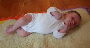 Side lying tummy time- use a rolled up towel behind the baby.