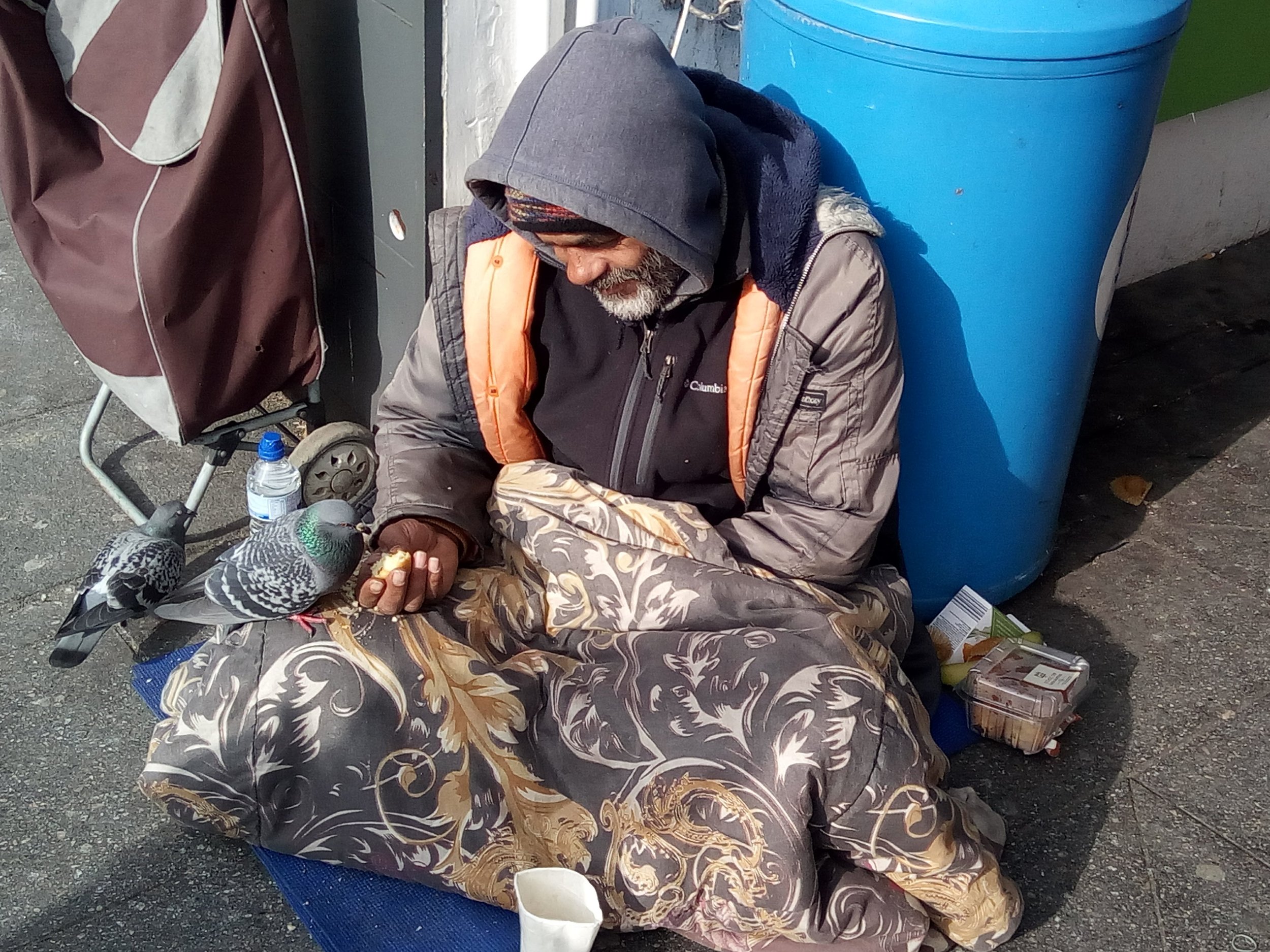 Act of kindness homeless man feeding pidgeon.jpg