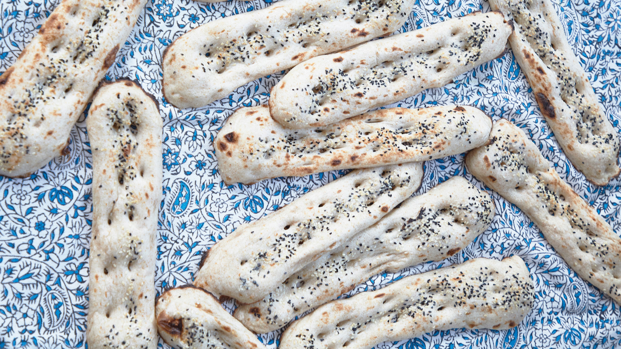 Assortment of breads on a blue and white apron