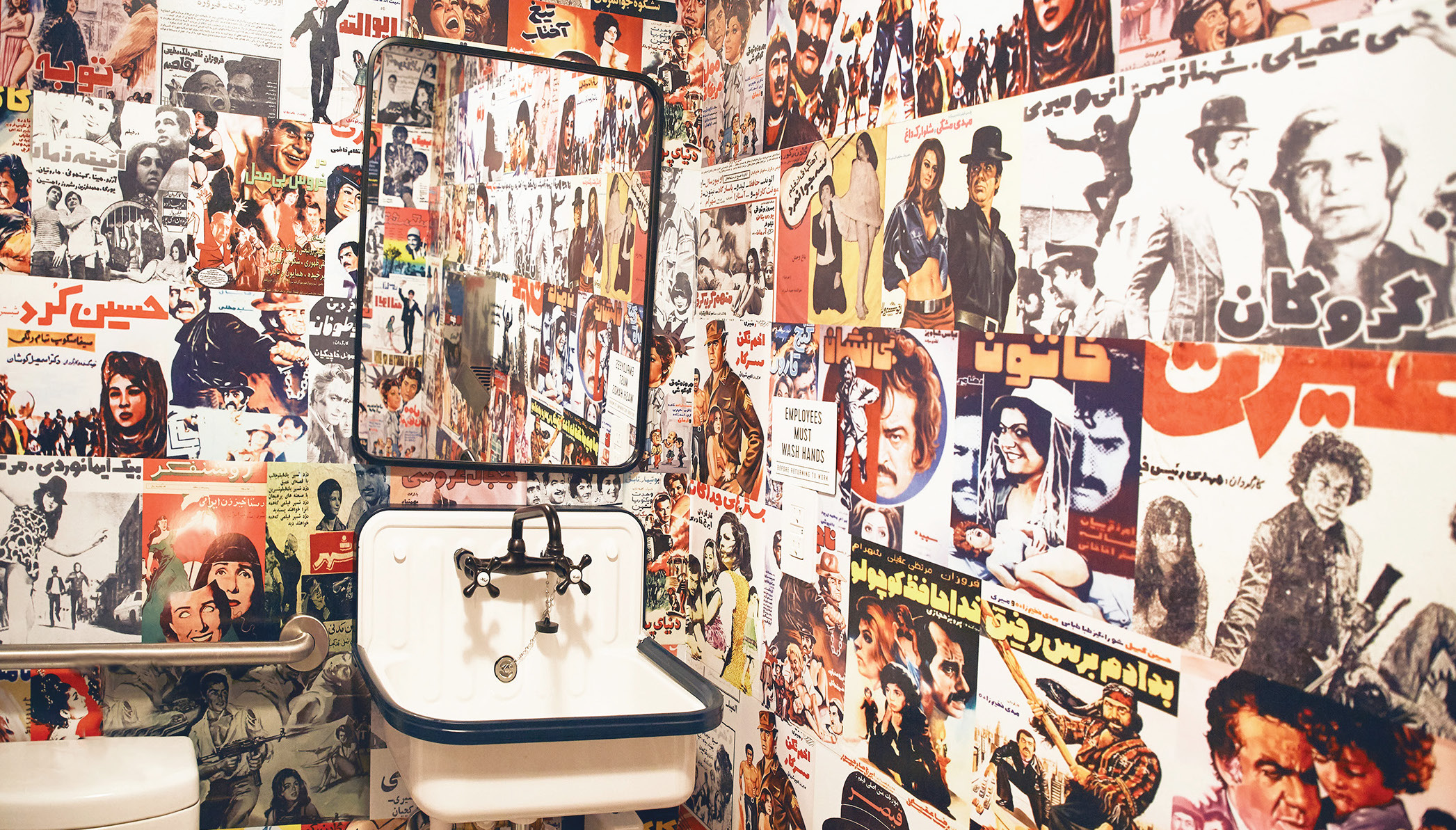 The main bathroom with color posters from old Persian movies