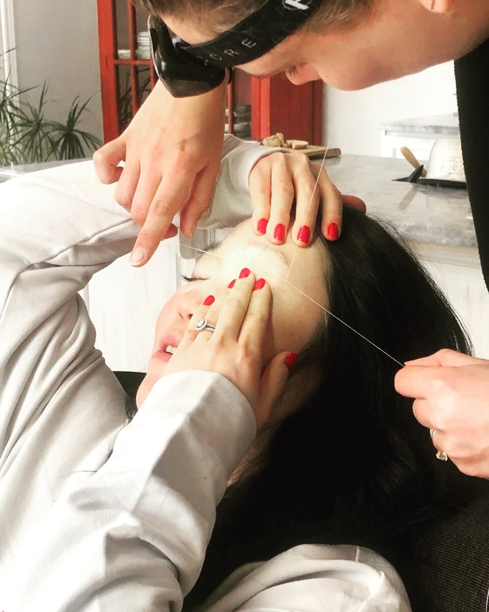 Threading in progress - how my client holds their brows while I thread is extremely important. A tight hold makes it less painful and helps me do my job quicker and more effectively.