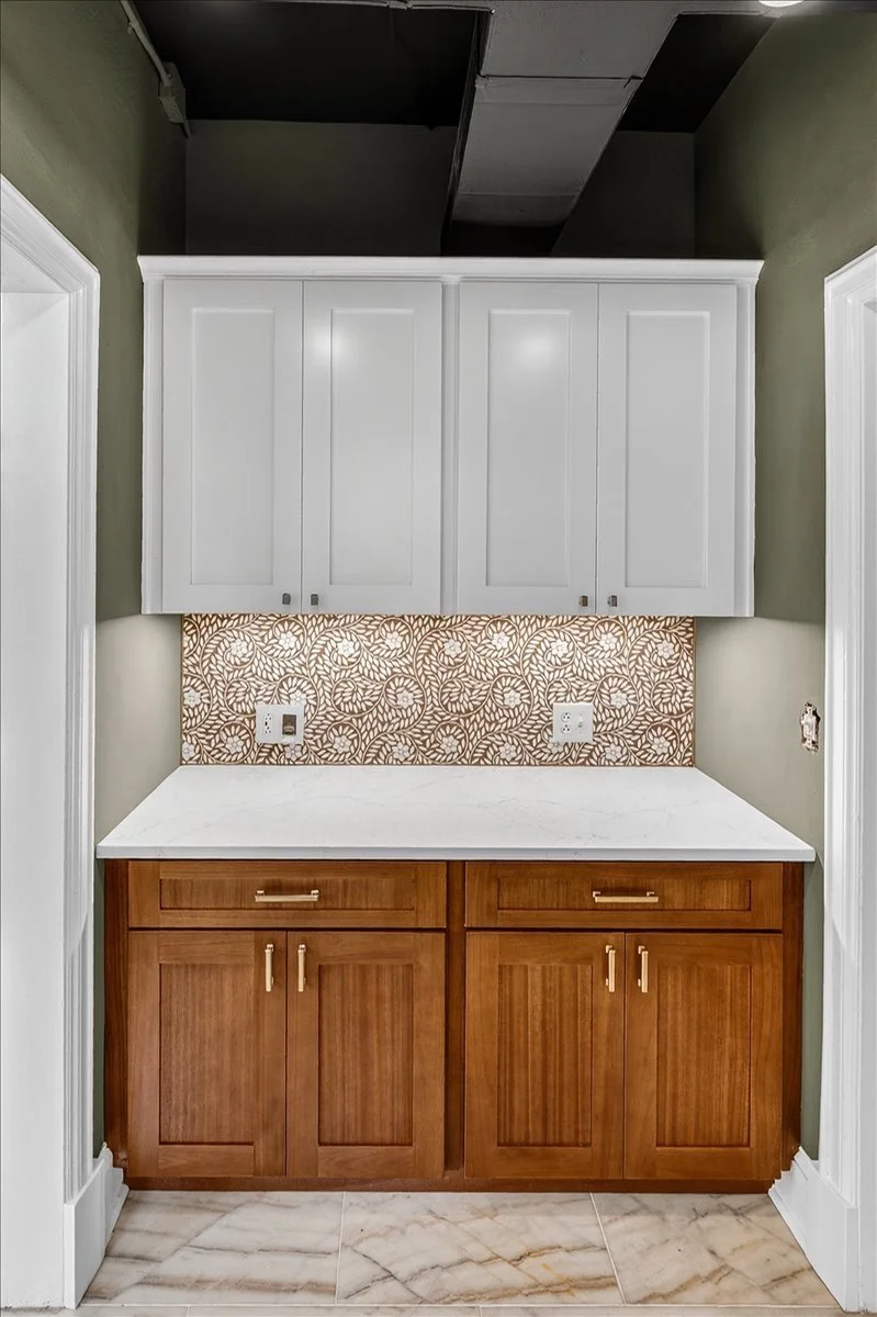 Custom wood cabinetry paired with a decorative mosaic tile backsplash.