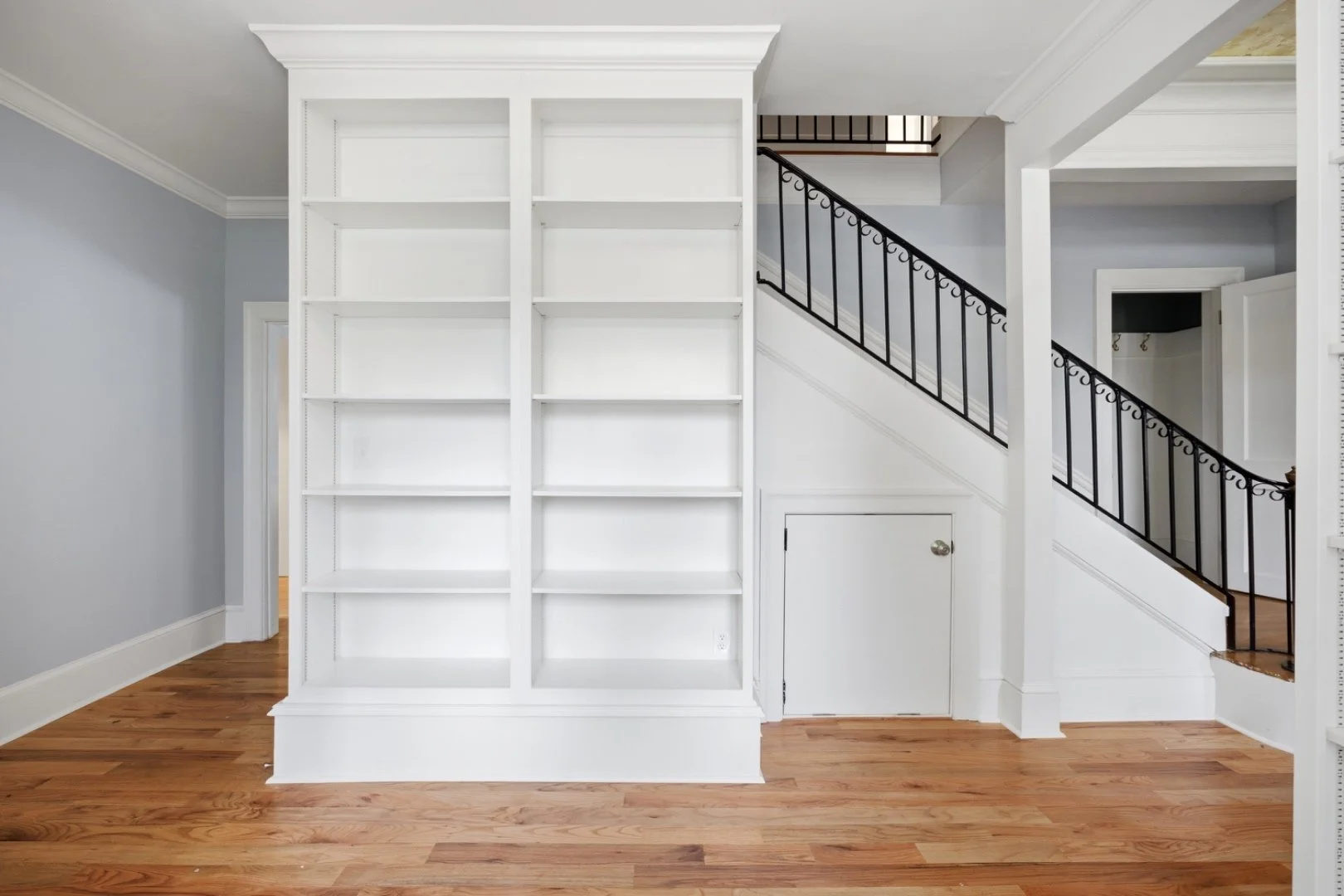 Built-in shelving tucked beneath the staircase — no space wasted.