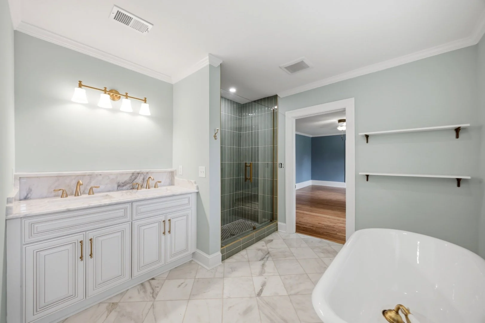 A custom double vanity anchors this spa-style bathroom.