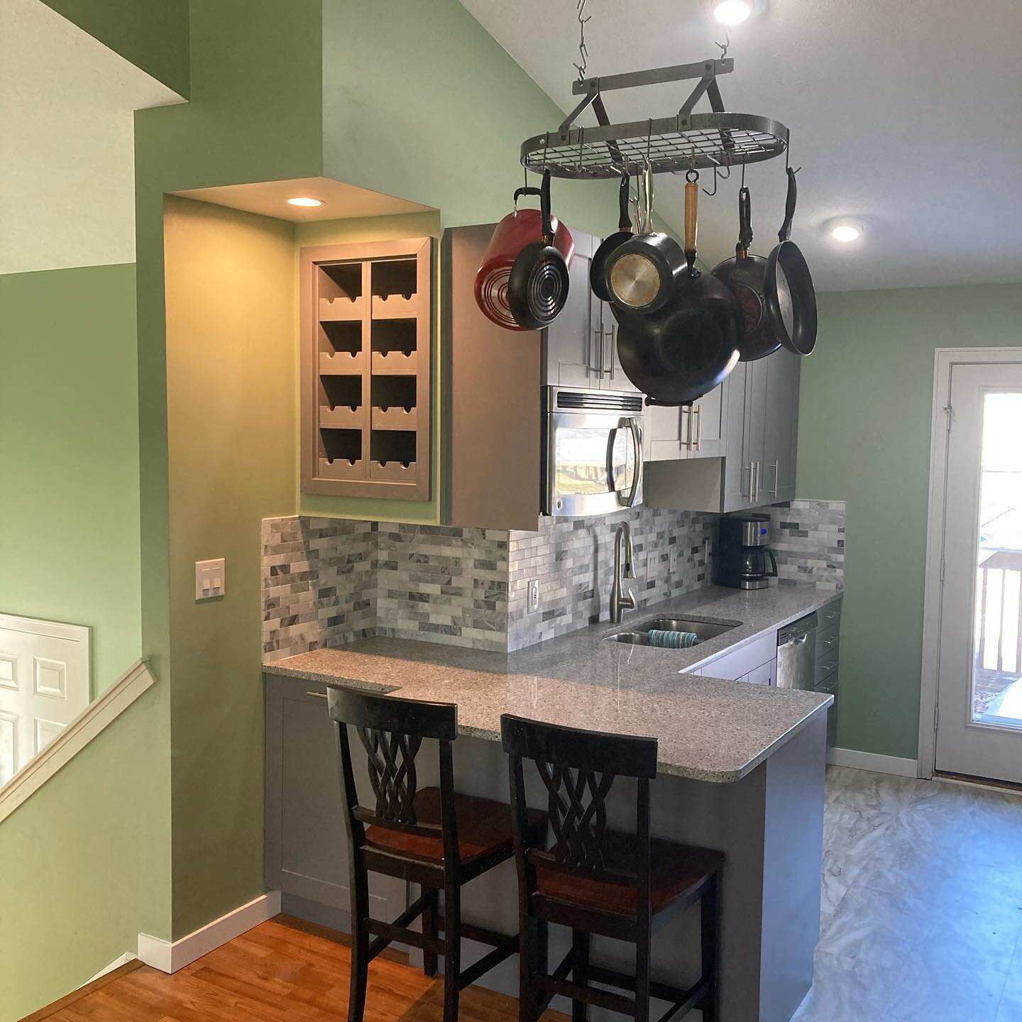 Our latest kitchen remodel was a success! Lots of added features for this kitchen! A built in wine rack, hanging pot rack, floor to ceiling pantry, custom built in knife block and sheet pan cabinet, and a hood vent to name a few. Even added some mult