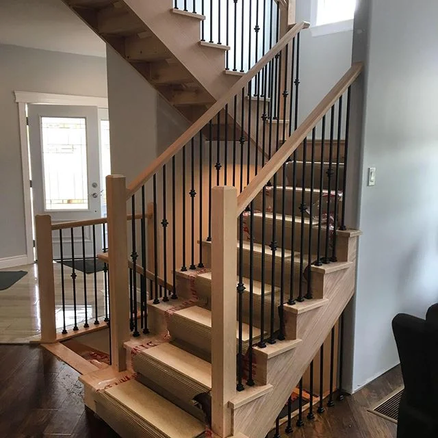 Contemporary oak posts with 1/2&rdquo; square metal spindles and standard handrail.  Installed for @barrietrim #railings #stairs #finewoodworking #custom #interior #interiordesign #metalspindles #oak #wood #design #woodwork
