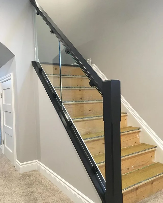 Contemporary chamfered post with custom made handrail and tempered glass. #railings #finewoodworking #glass #custom #interior #interiordesign #carpentry #finishcarpentry #stairs #design
