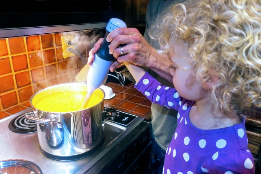 Ellie helping to make west african peanut soup, a staple in our house