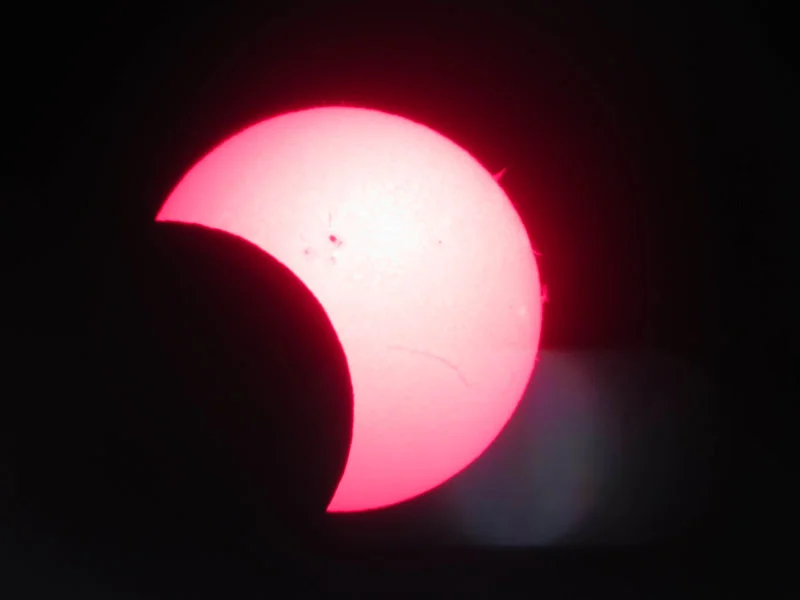Figure 2-3: An afocal image with a smartphone camera, handheld, of a partial solar eclipse through a Coronado Personal Solar Telescope.