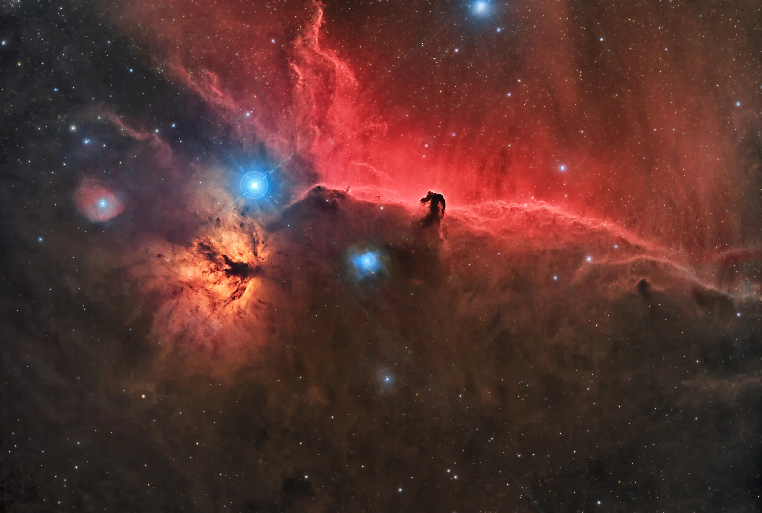 Image by Andy ChatmanNGC 2023 - Horsehead and Flame NebulaeThe Horsehead and Flame Nebulae region in the constellation Orion. The horse head shape is silhouetted against a backdrop of illuminated hydrogen gas.This image was taken from Samphran, Thai…