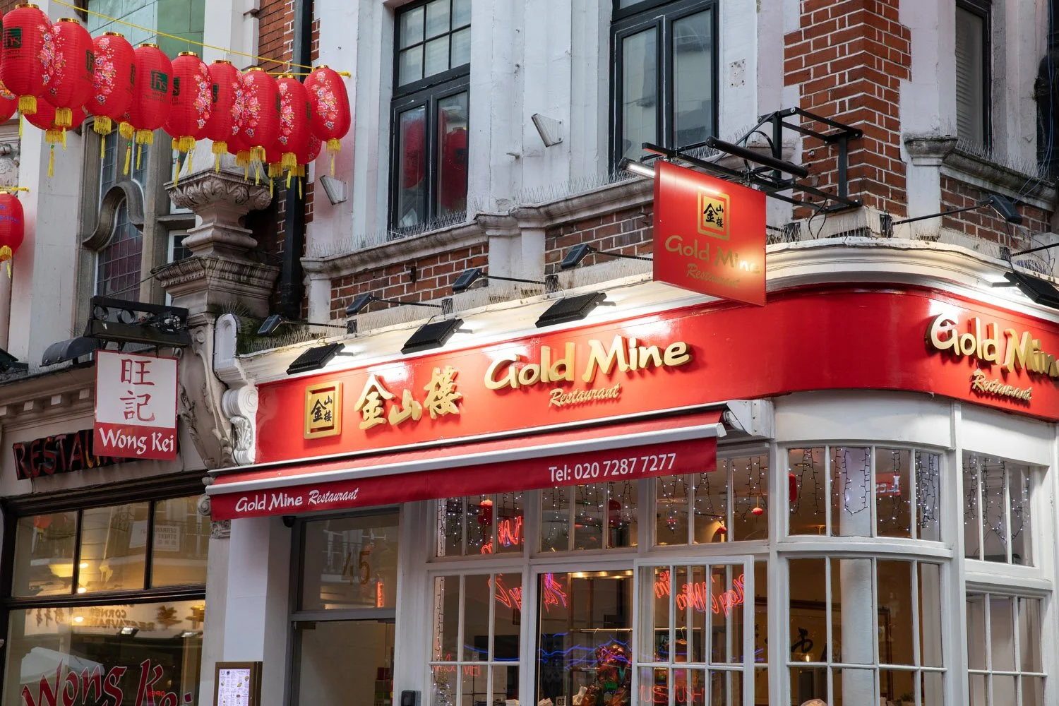 In Chinatown in London, fresh red lanterns are hung from the buildings to celebrate the Chinese New Year. The frontage of this restaurant, named Gold Mine, is decorated in the red and gold colours associated with luck and prosperity.
