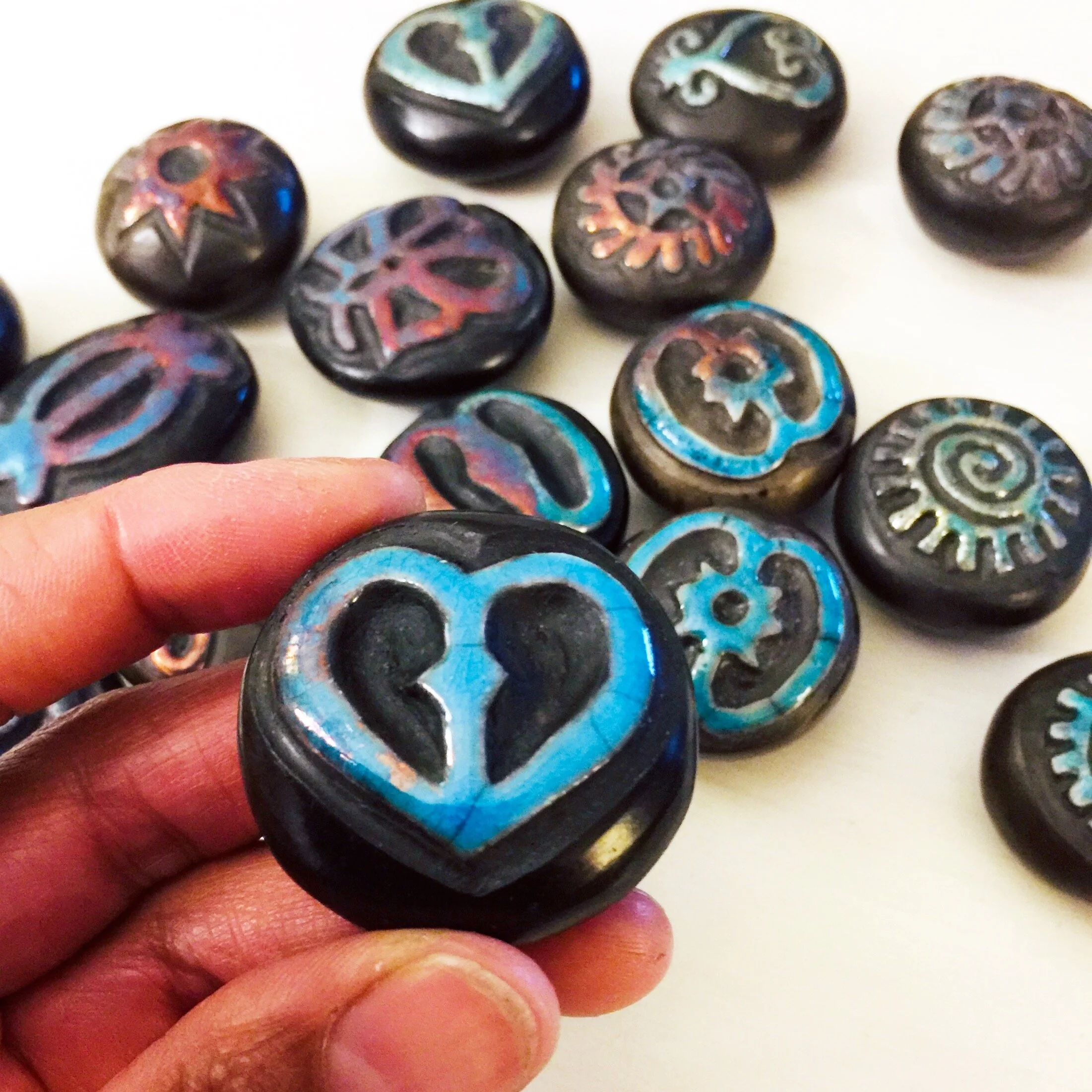 Akoma Adinkra stone in hand.JPG