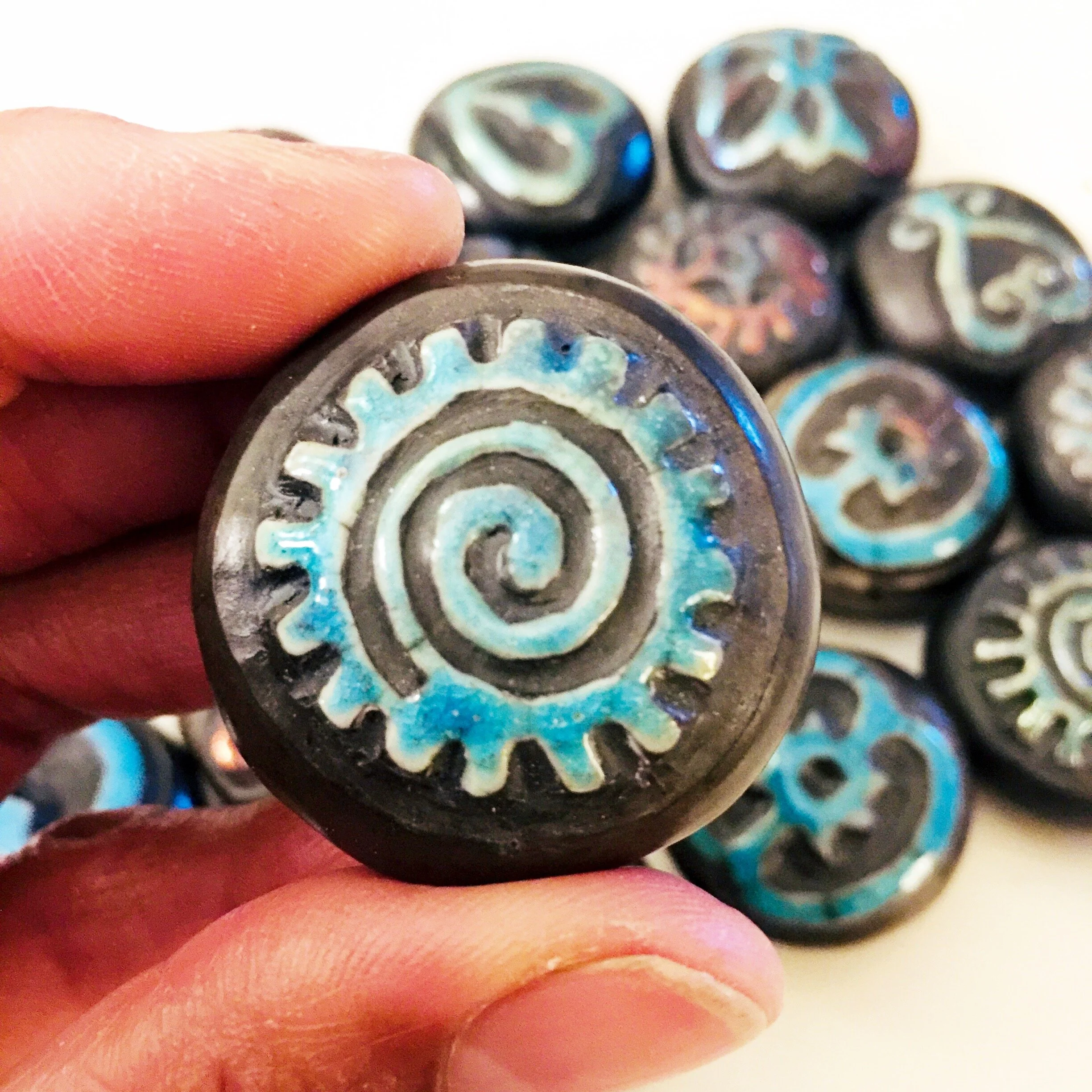 Adinkra stone close up in hand.JPG
