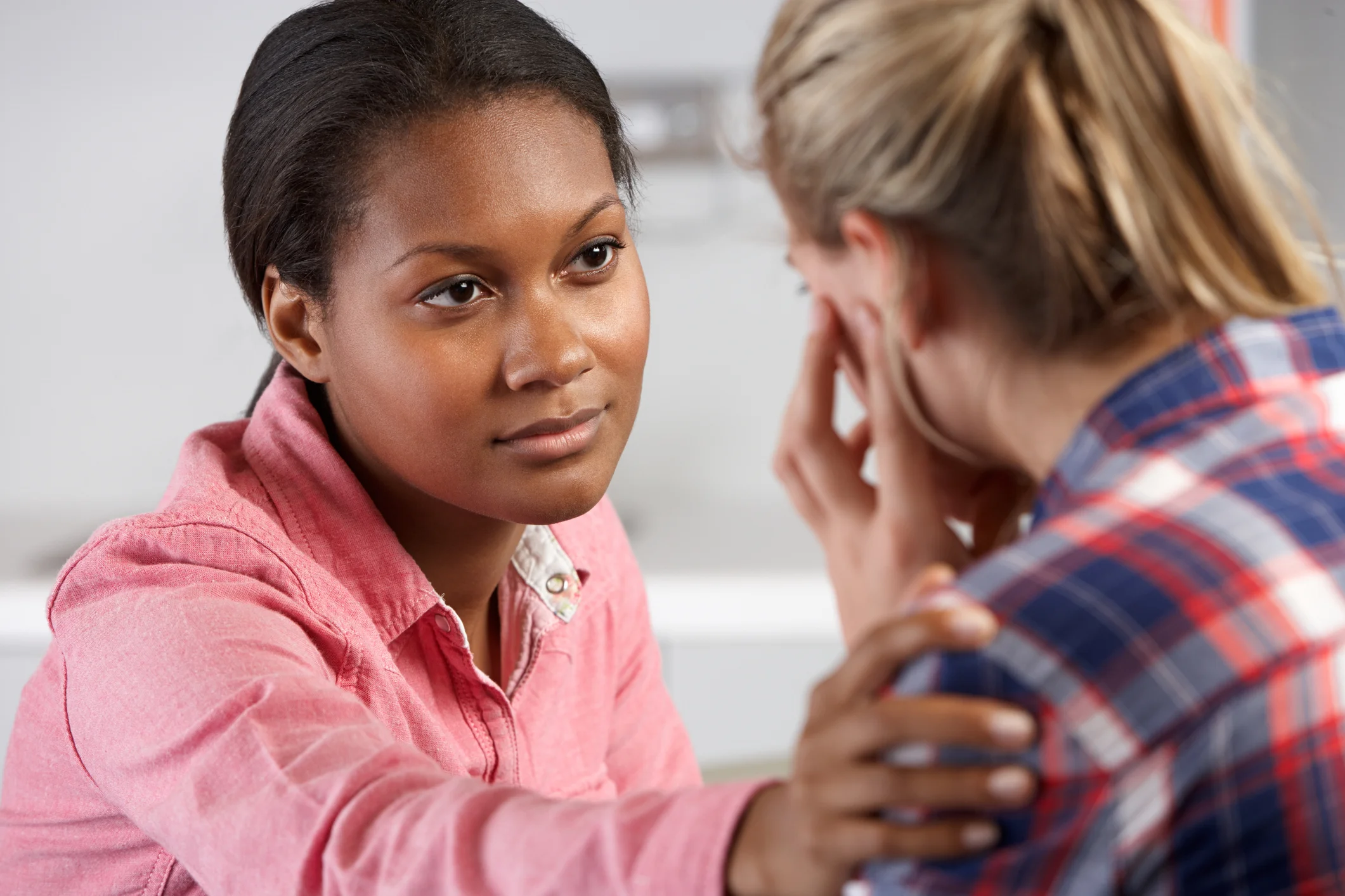 An educator talking with a student in a classroom
