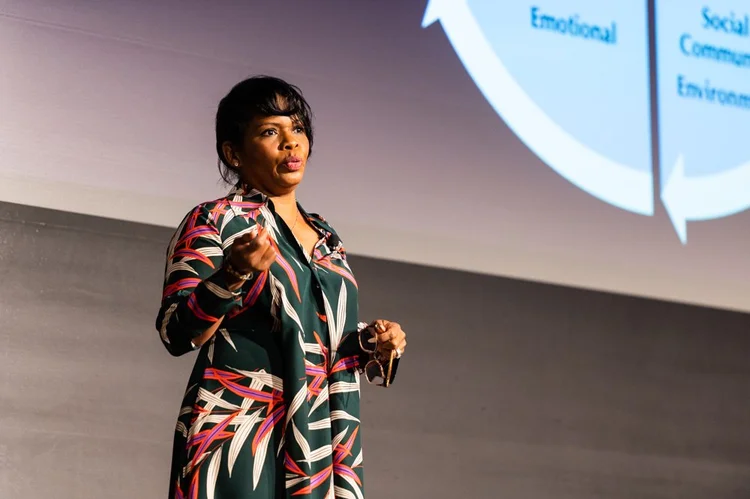 A keynote speaker presents on stage
