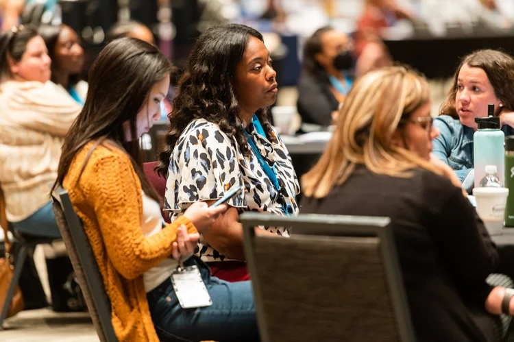 Audience members participate during the conference