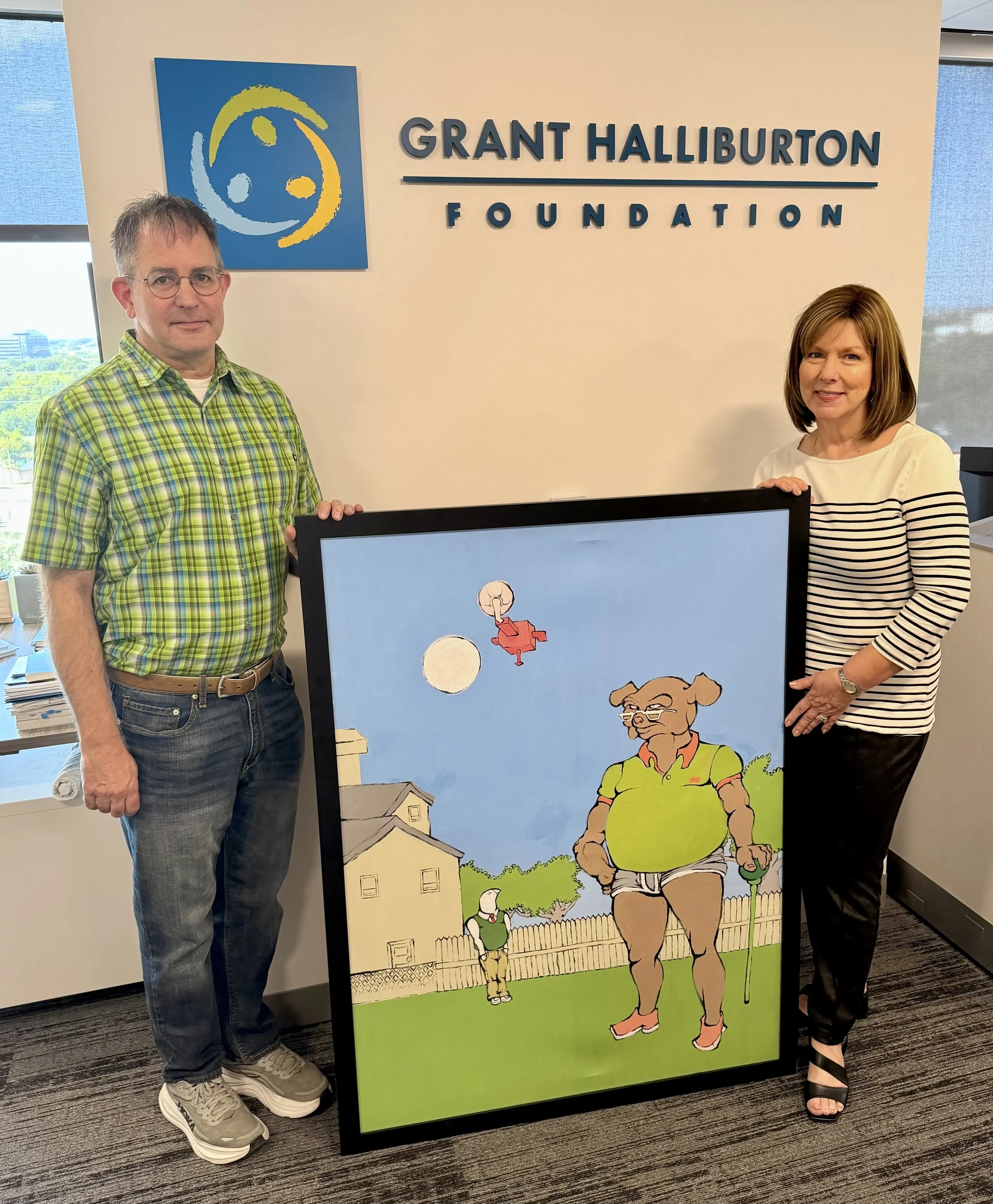 Vanita Halliburton stands with Douglas Darracott, Grant Halliburton’s former Plano West art teacher, in the Grant Halliburton Foundation office beside one of the pieces of Grant’s artwork he returned to the family.