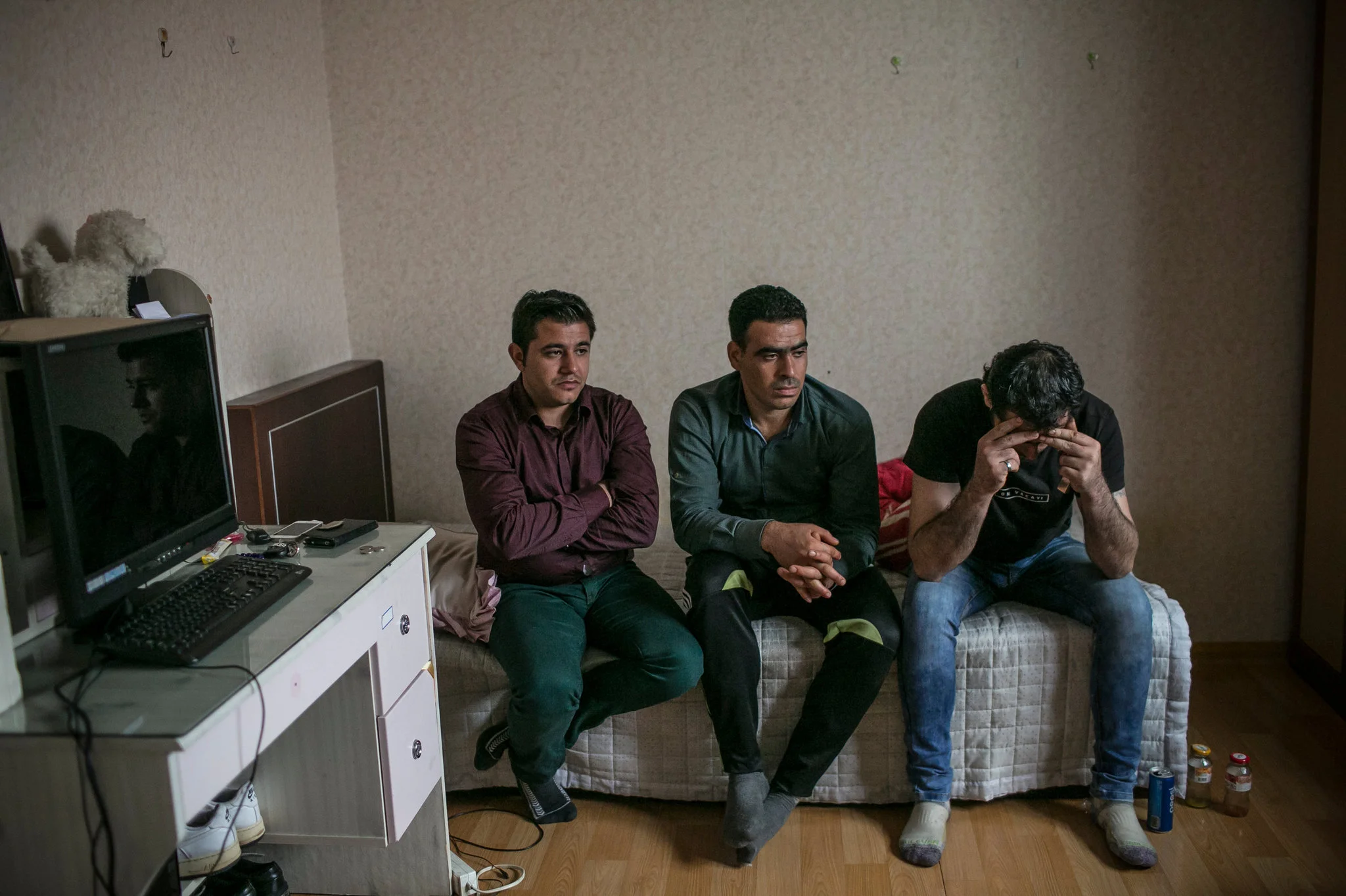 Ahmad Barro, left, Ahmad al-Othman and Ahmad Khalifa last month in Yangju, South Korea. The men, all from Syria, expressed frustration as they talked about family members left in Aleppo. Credit - Jean Chung for The New York Times