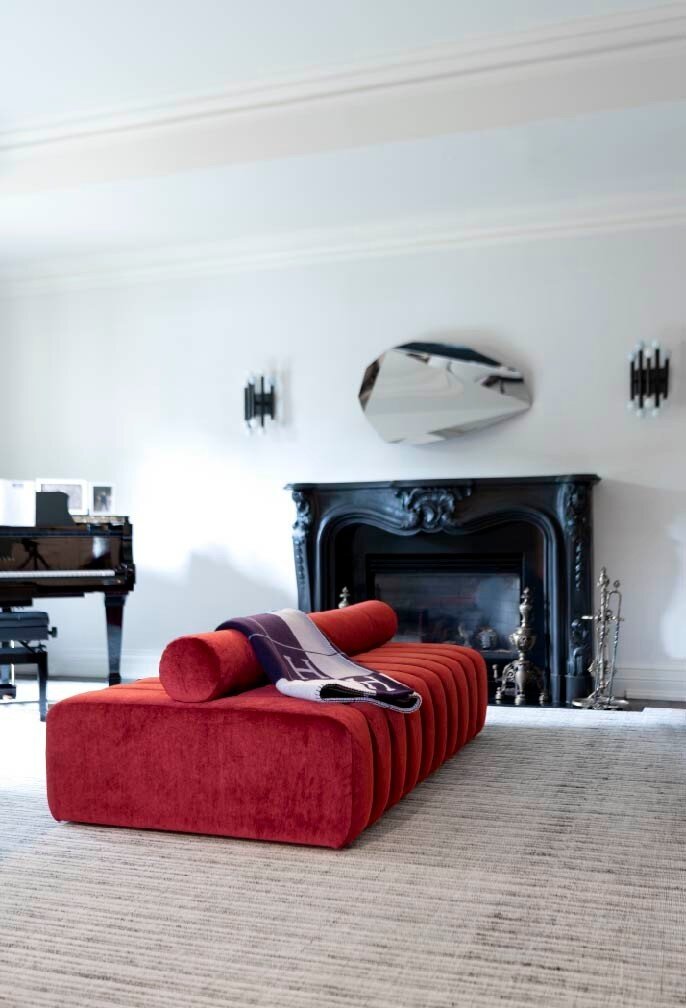 Traditional bones, modern vibe.

This previously formal living room had dark brown glasscloth wallcovering, traditional sconces and heavy furniture.  When the clients bought the house, preserving the character of the home was important but so was mak
