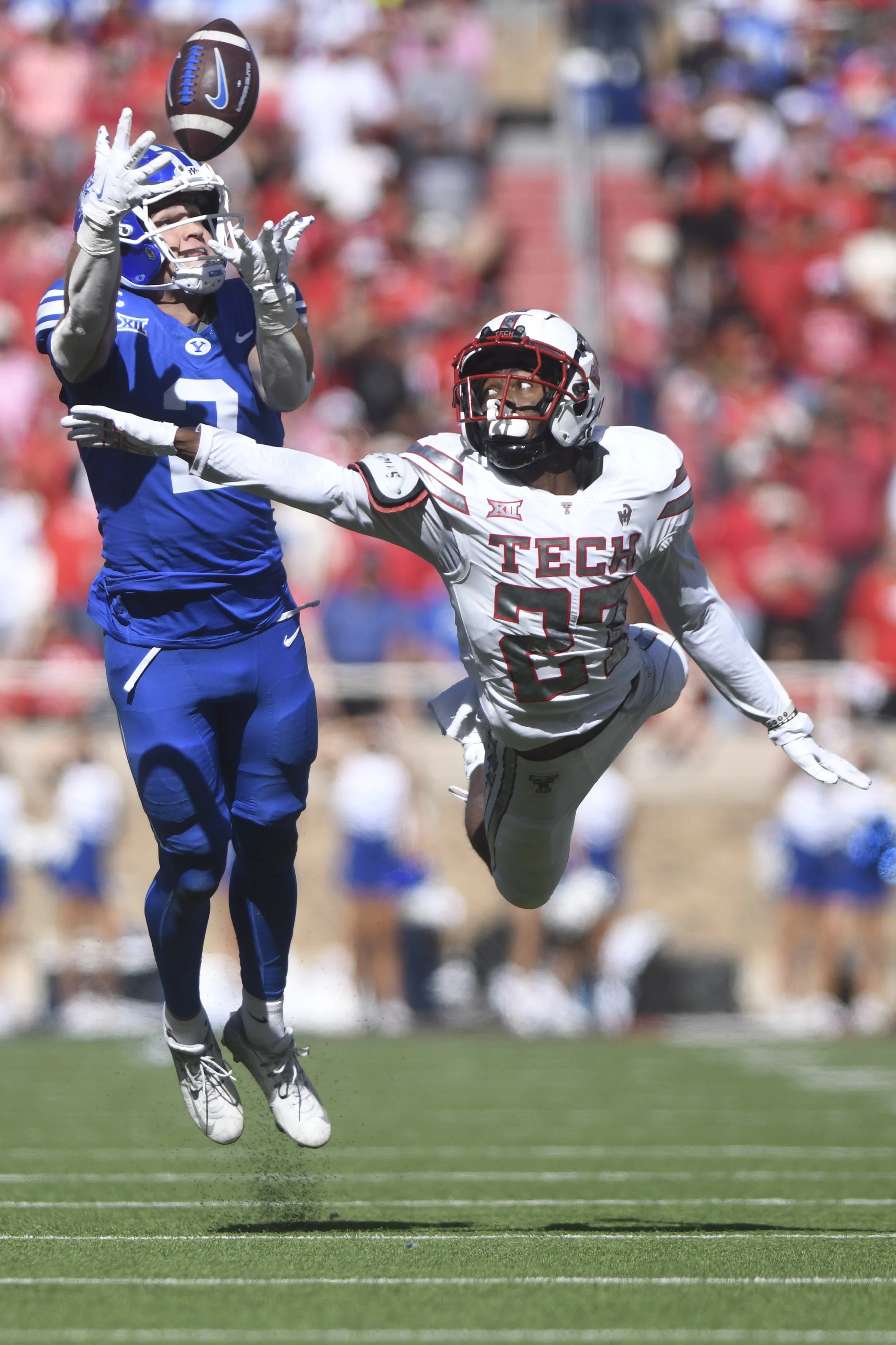  BYU wide receiver Chase Roberts (2) reaches for the pass while Texas Tech defensive back Amier Boyd (27) attempts to block during the second half of an NCAA college football game, Saturday, Nov. 8, 2025, in Lubbock, Texas. Roberts did not complete t