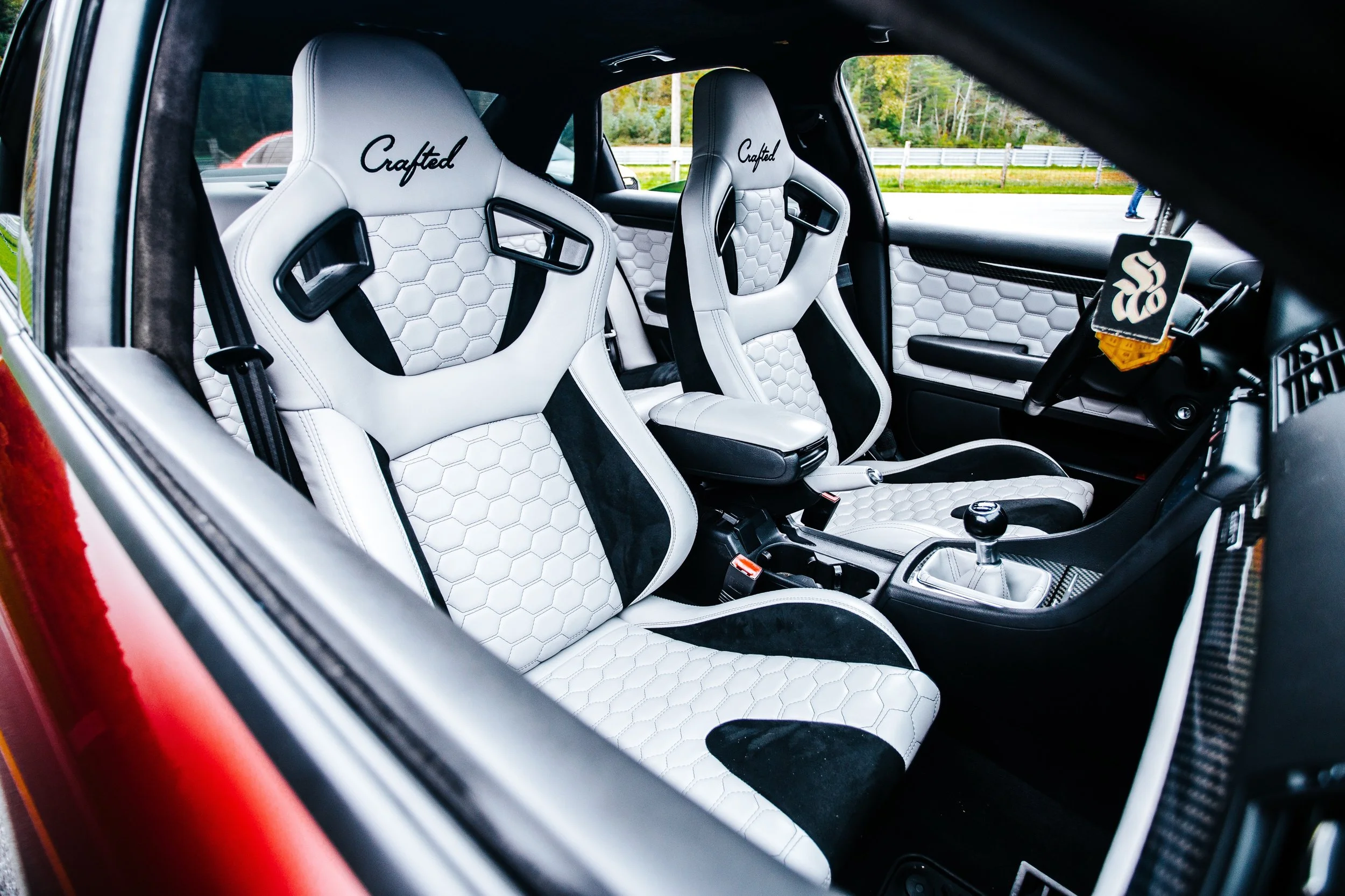 NW Crafted custom racing seats, Silver hexagon stitched leather with a black micro -suede accent. Matching door panels, and custom console with matching shift boot.