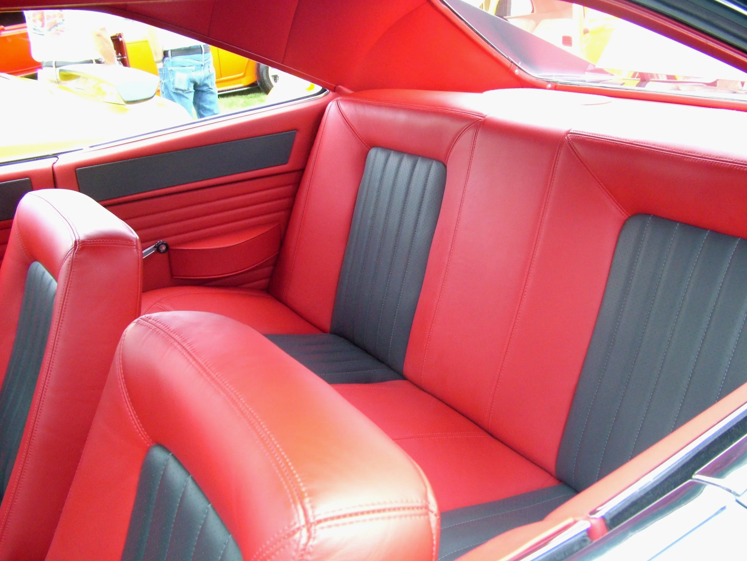 Charger- full custom interior with red and grey leather seats, red leather headliner and side panels, and matching door panels.