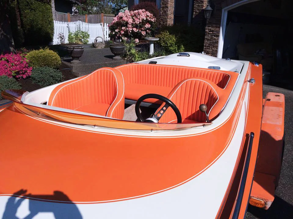 Full custom speed boat interior - custom orange and white lined leather seats.