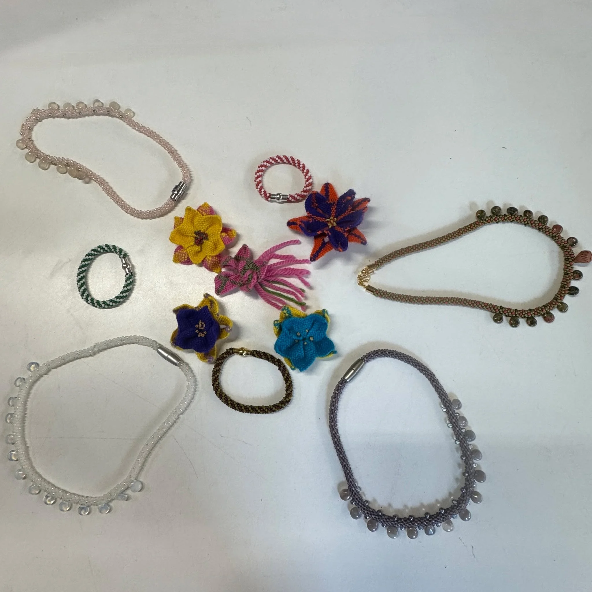 Jewelry doesn't always have to be made of metal. Here are some of the amazing results from my 5 week long Kumihimo braiding class. I think the braided beaded necklaces and bracelets came out amazing, and the flowers were made from the square disk, an