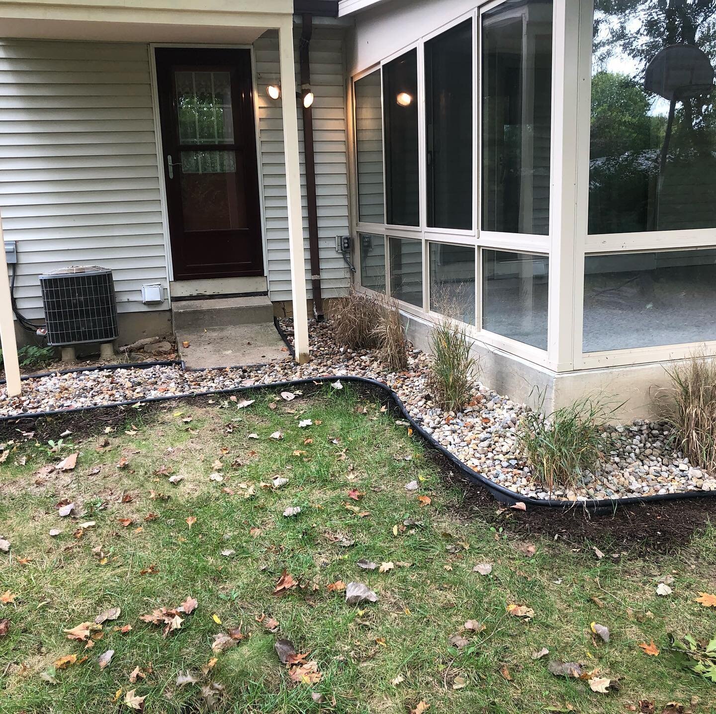 Defined beds, laid rock and planted ornamental grasses