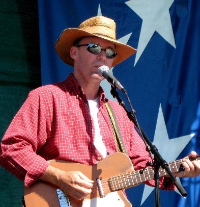 photo of Michael McNevin on stage withh guitar