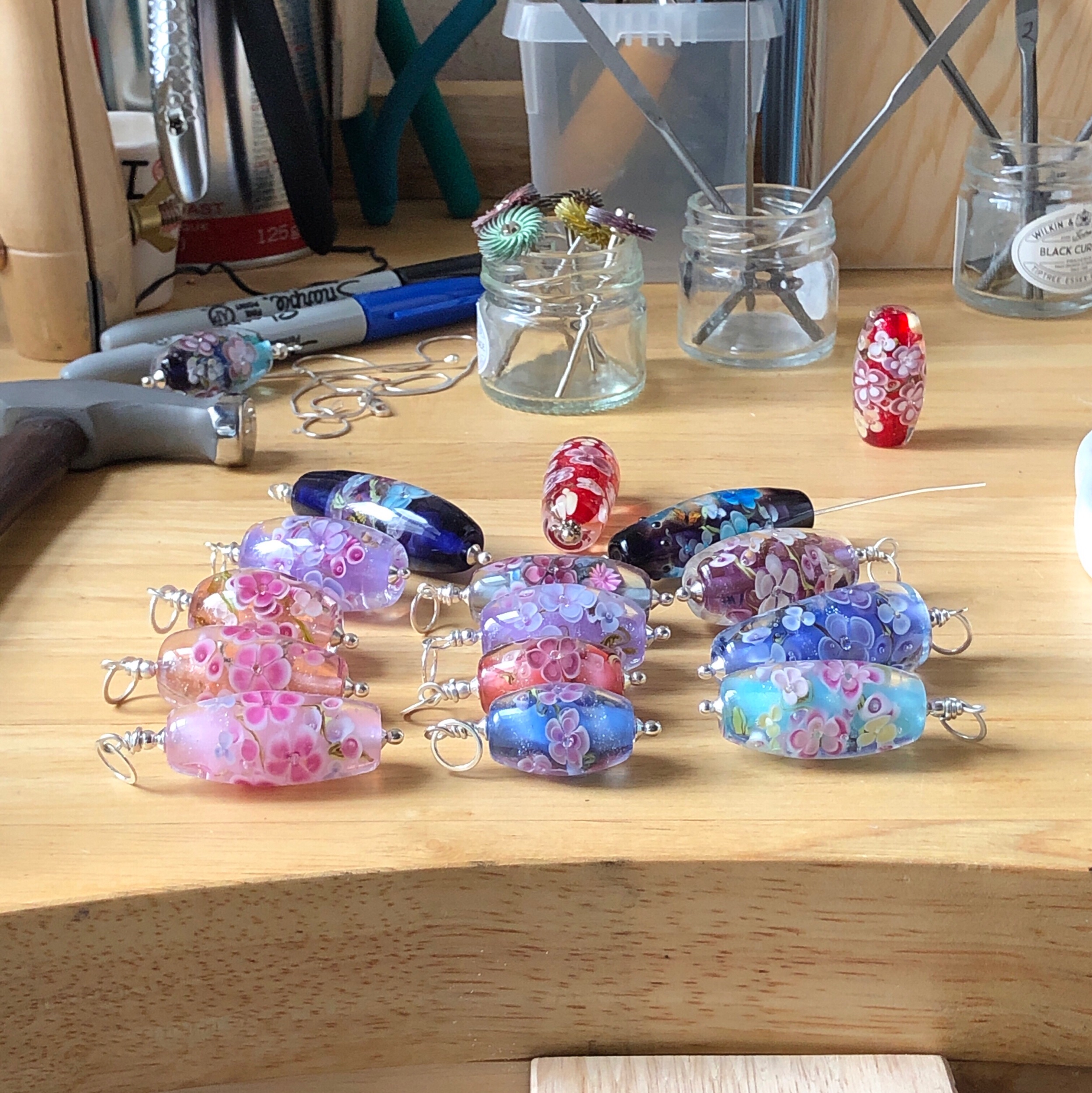 Floral beads on jewellery bench.jpeg