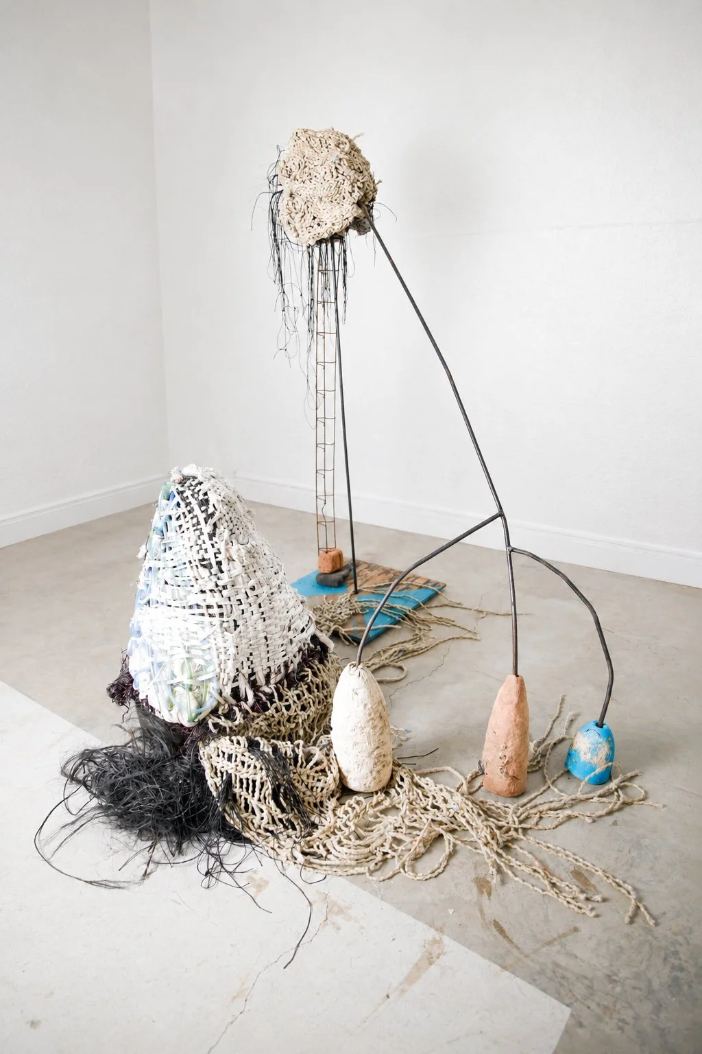 Every Strange, Half Seen, Gliding, Beautiful Thing, 2026,  collected debris, steel, polyester pull tape, maple sugar tubing, metal lampshade structure, tire, canvas tarp, wood, wire, 78x96x52” 
