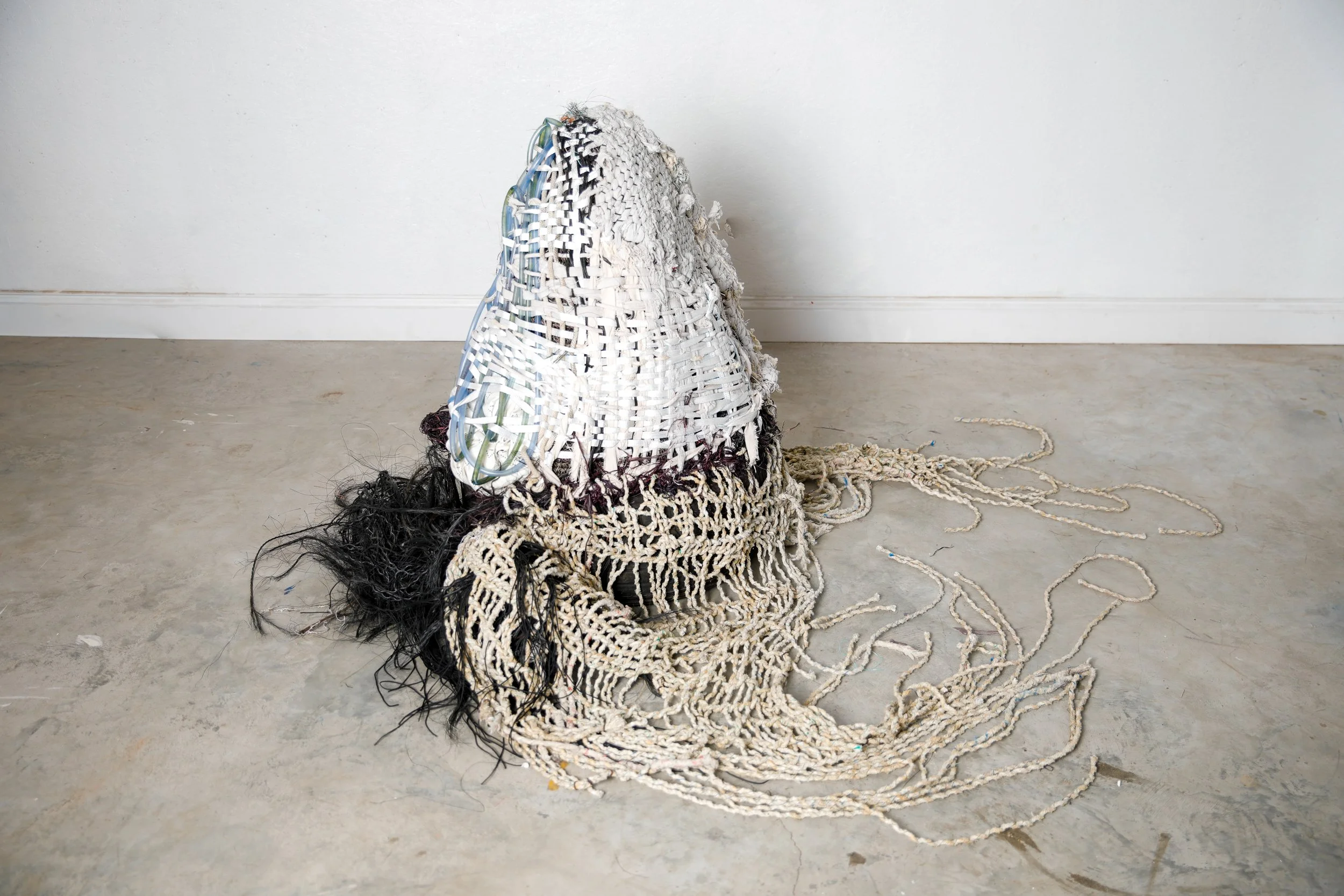 Shoalwater, 2026, collected marine debris, polyester pull tape, maple sugar tubing, metal lampshade structure, tire, canvas tarp, 36,42x36”