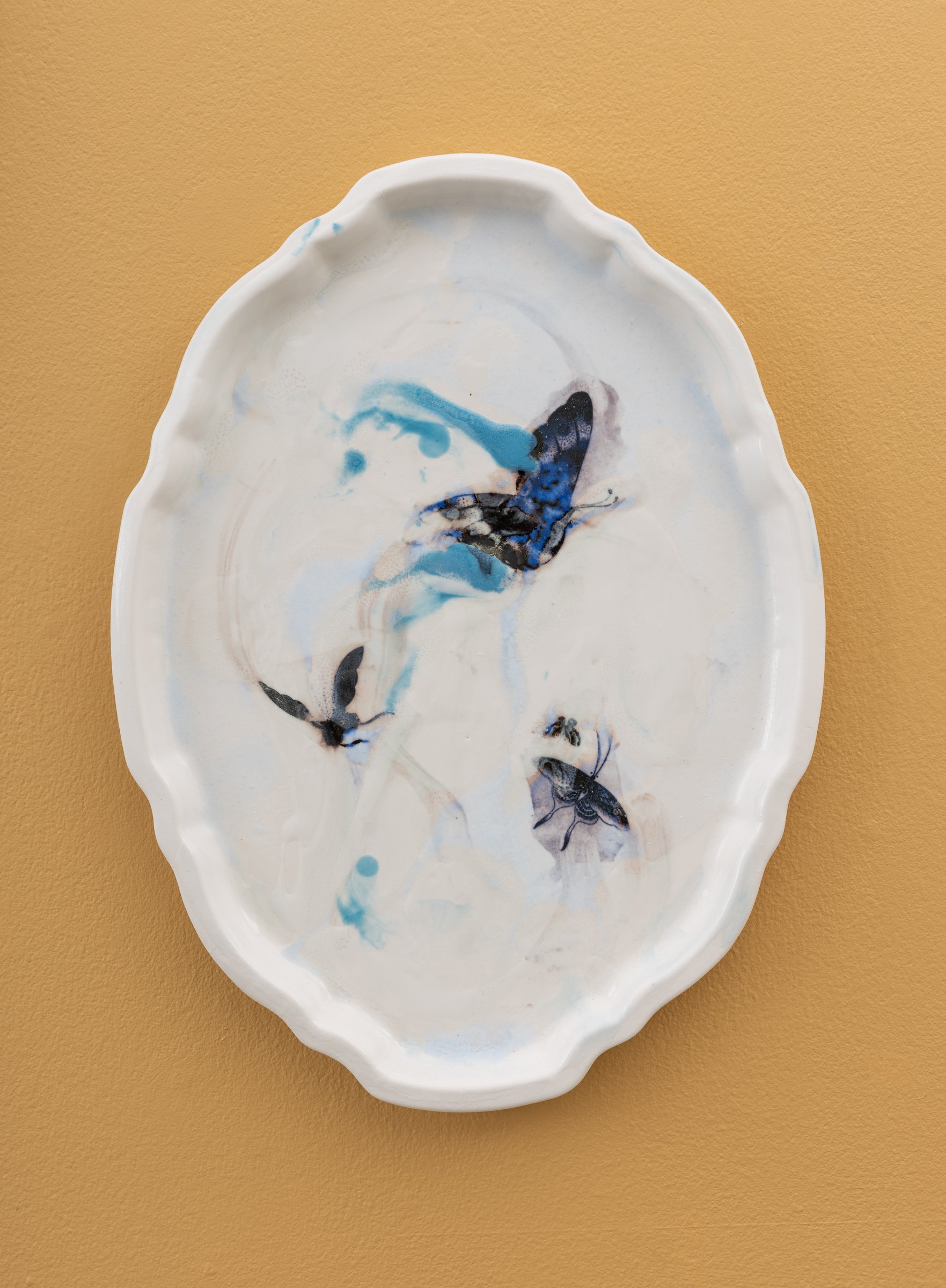  Why do Europeans put plates on their walls? XIV | 2022  Porcelain, glazes, porcelain decals and tissue paper, press molding. 39x30x3cm  Photo: Thomas Tveter 