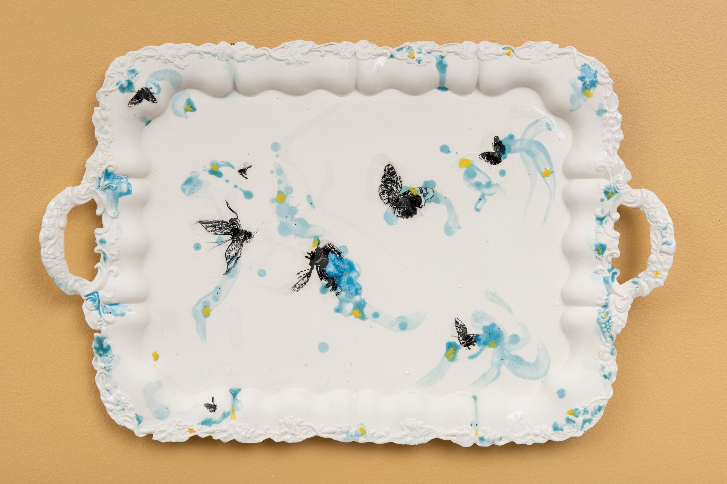  Why do Europeans put plates on their walls? IV | 2022  Porcelain, glazes, porcelain decals and tissue paper, press molding. 64x42x4cm  Photo: Thomas Tveter 