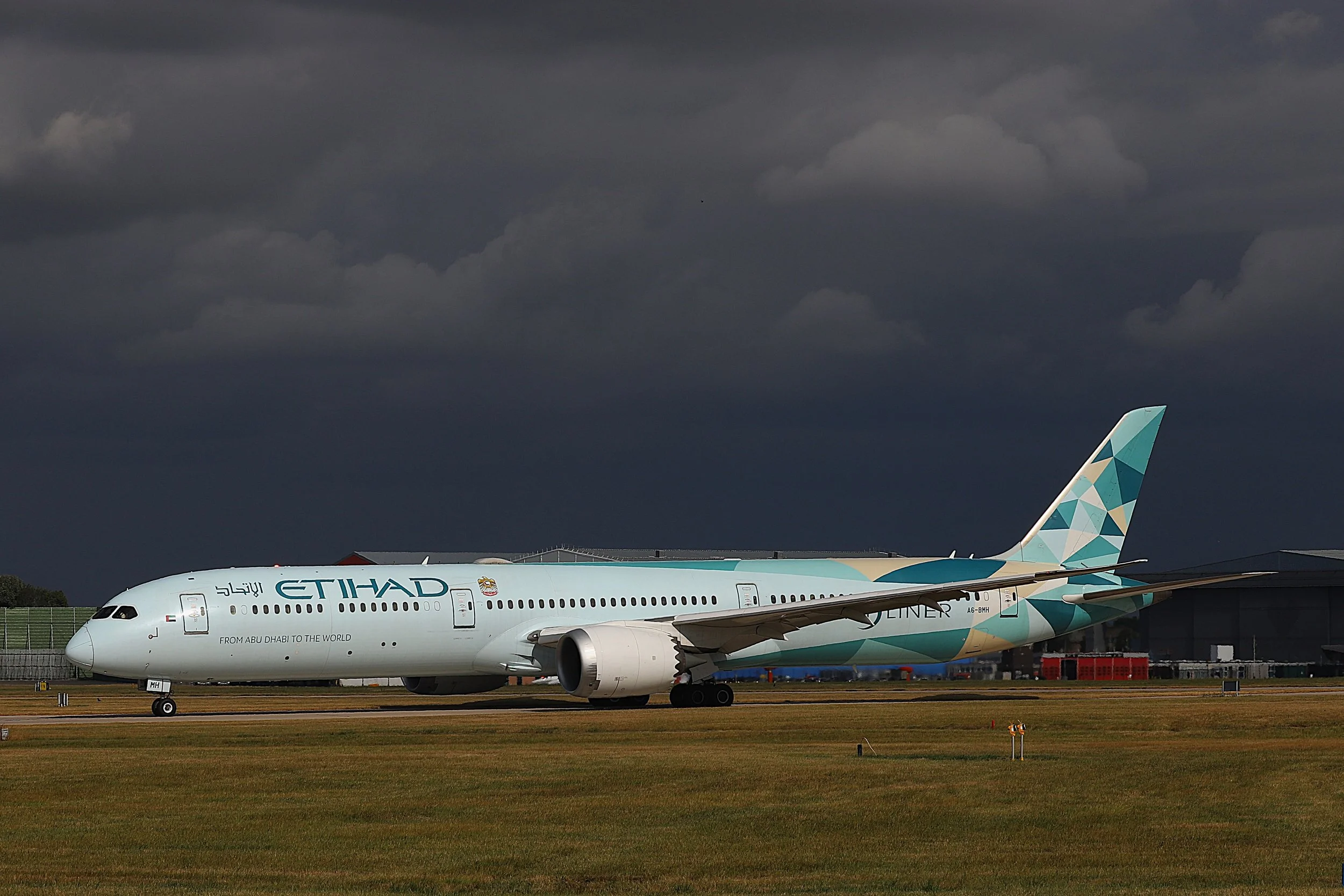 31st July 2026 - a dramatic backdrop to Etihad B787-10 Dreamliner A6-BMH in the Greenliner Livery.  Photo: Greg Mape